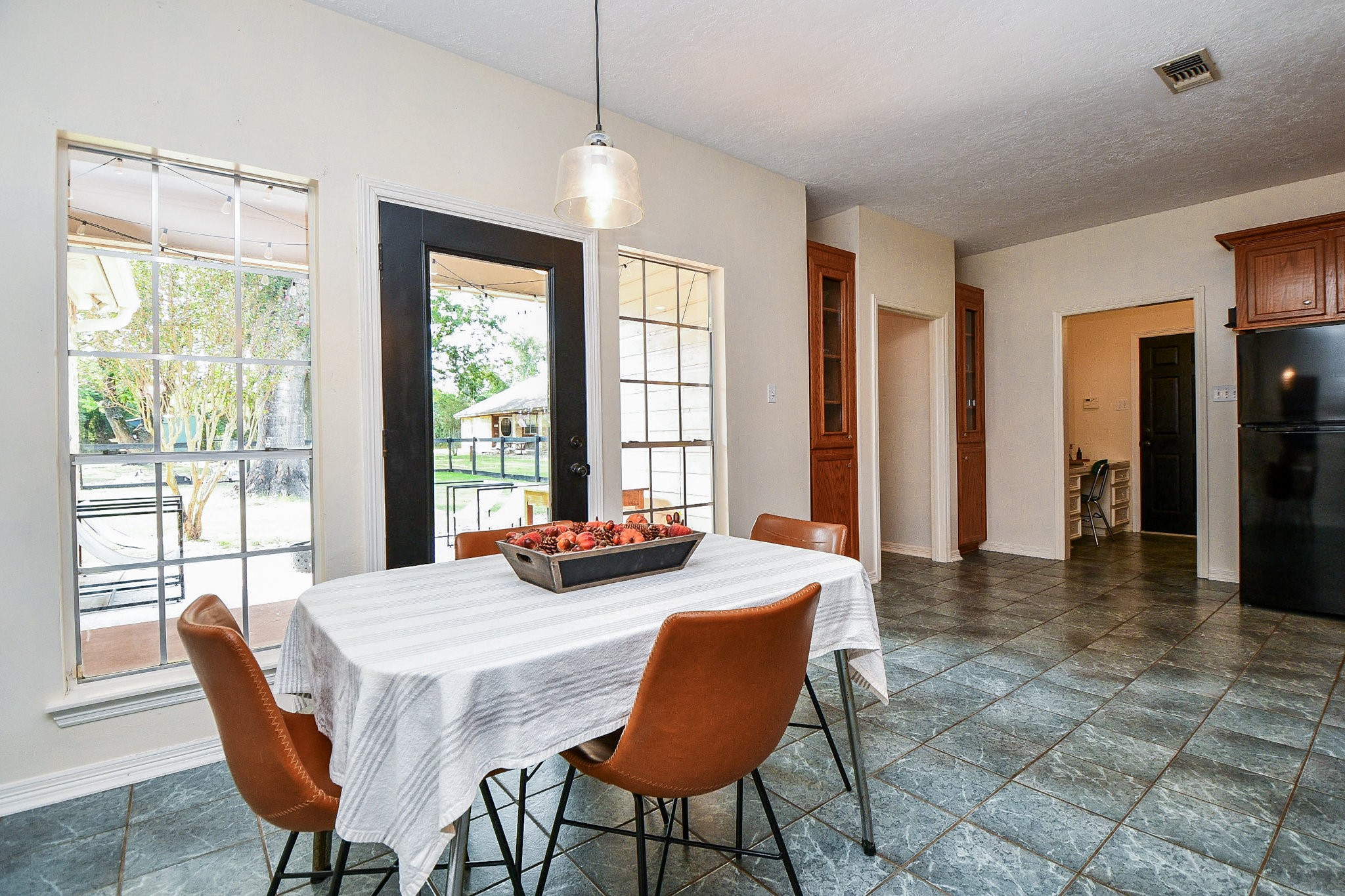 Large, open dining area with access to the covered back porch in the primary house
