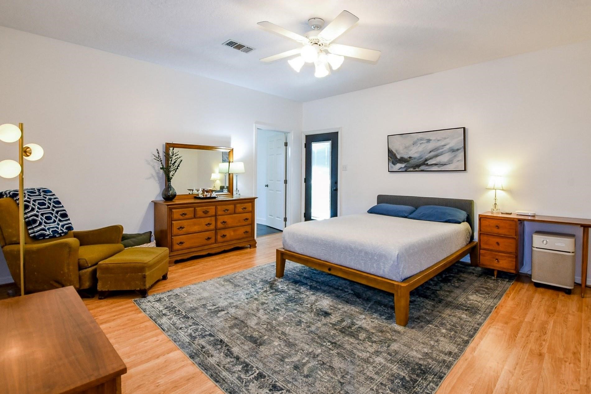 Large primary bedroom with access to the rear covered porch
