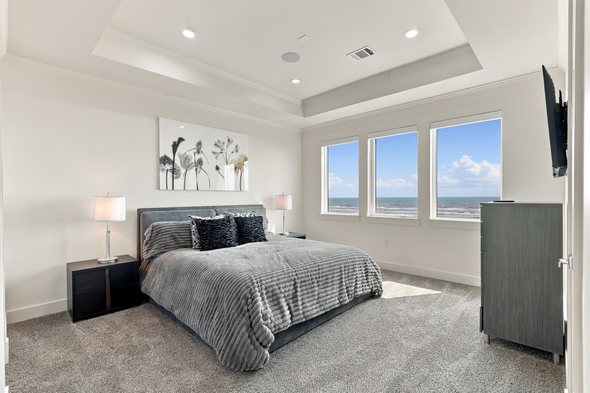 Forth Gulf-view bedroom
Three windows capture sweeping beach and Gulf views from this inviting bedroom. A tray ceiling, recessed lighting, and soft carpeting complete the relaxing waterfront setting.