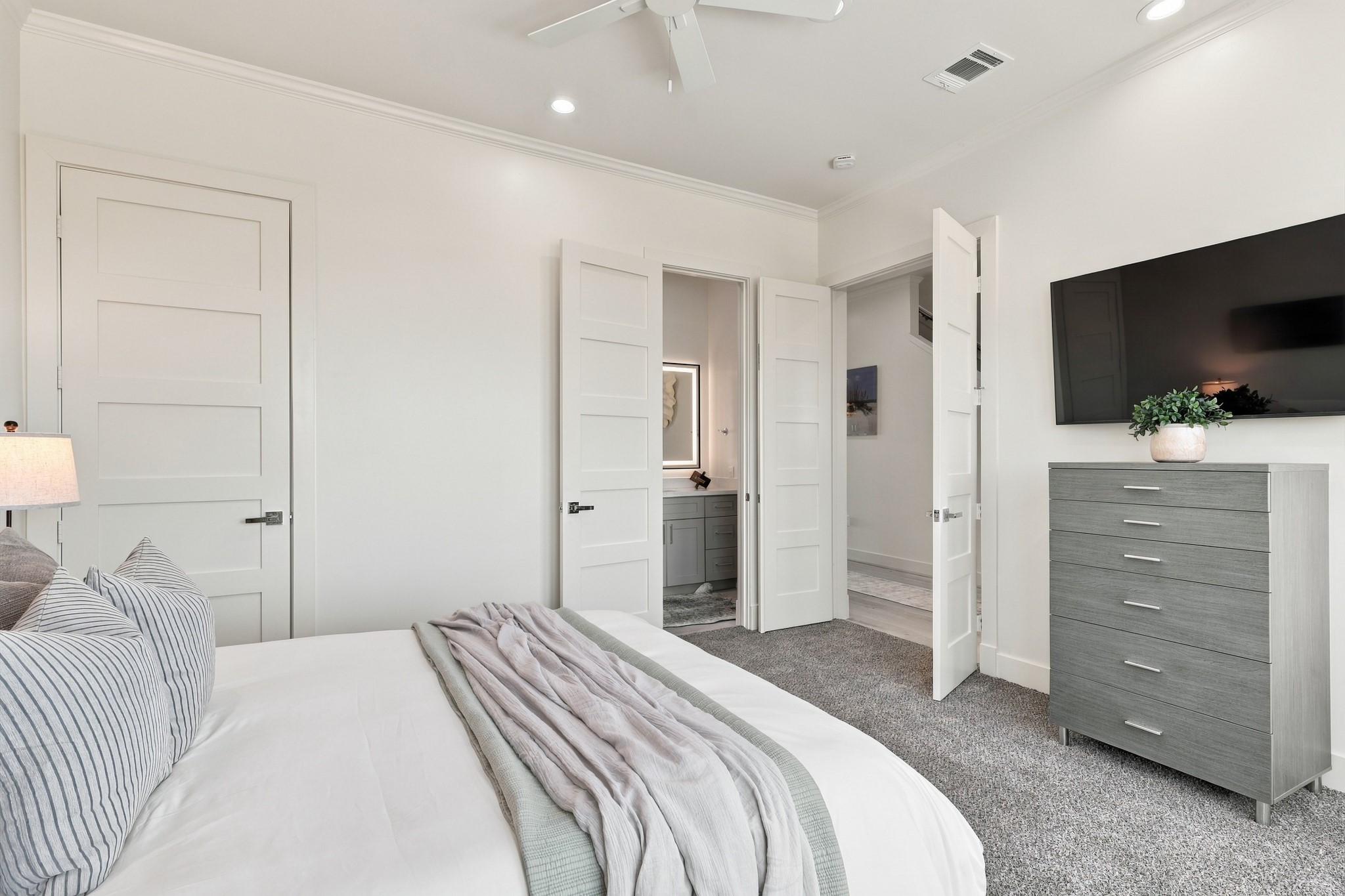 Secondary bedroom, alternate view
An alternate view highlights the bedrooms comfortable proportions, soft carpeting, and direct access to an adjoining bathroom.