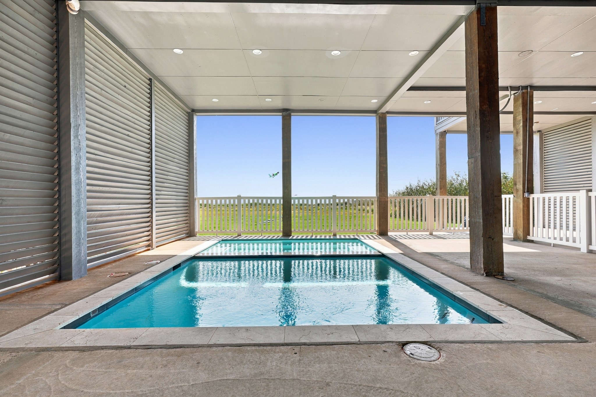 Covered pool and spa
Enjoy a private pool and adjoining spa beneath the homes covered outdoor area. Open views toward the dunes and Gulf create a distinctive setting for relaxing after a day on the beach.