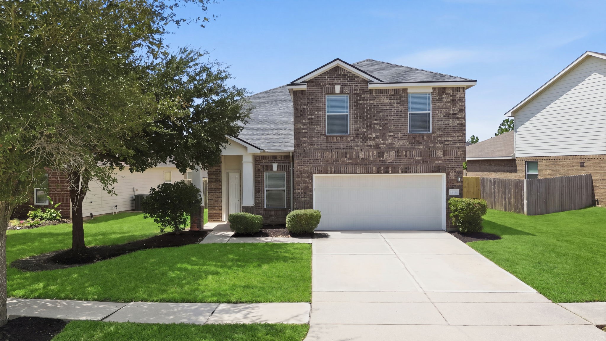 A classic brick facade, 2-car garage, and double-wide driveway highlight the striking exterior of this two-story Cypress Landing residence.
