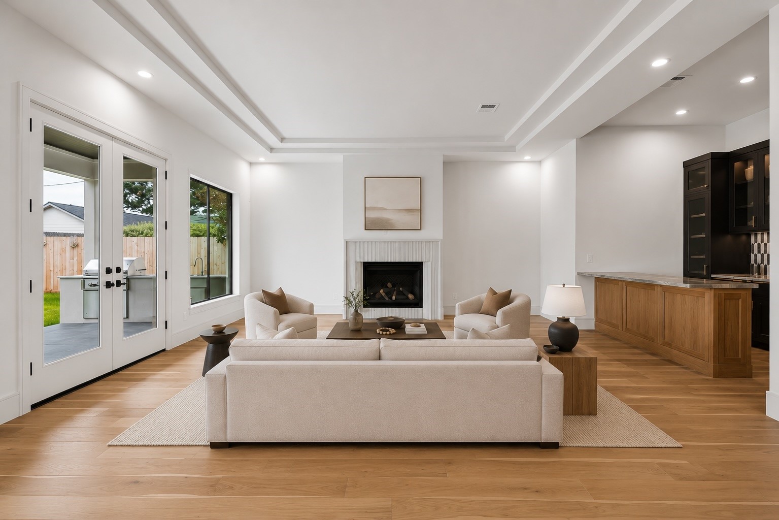 Gather around the fireplace or open the doors to the covered patio for effortless indoor outdoor living. Soaring tray ceilings, expansive windows, and a seamless connection to the kitchen and wet bar make this the heart of the home. **Virtually staged** Gather around the fireplace or open the doors to the covered patio for effortless indoor outdoor living. Soaring tray ceilings, expansive windows, and a seamless connection to the kitchen and wet bar make this the heart of the home. **Virtually staged**