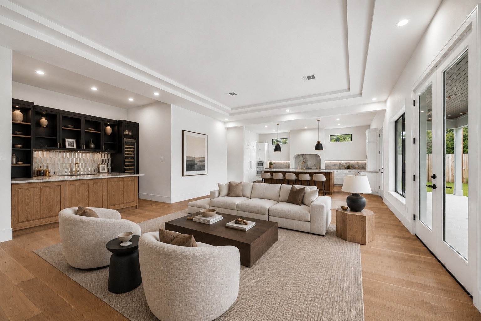 Designed for gathering, the open living room flows effortlessly between the chefs kitchen, wet bar, and covered outdoor living area. Soaring tray ceilings, expansive windows, and walls of glass create a bright, connected space that is equally suited for quiet evenings or entertaining a crowd. **Virtually staged** Designed for gathering, the open living room flows effortlessly between the chefs kitchen, wet bar, and covered outdoor living area. Soaring tray ceilings, expansive windows, and walls of glass create a bright, connected space that is equally suited for quiet evenings or entertaining a crowd. **Virtually staged**