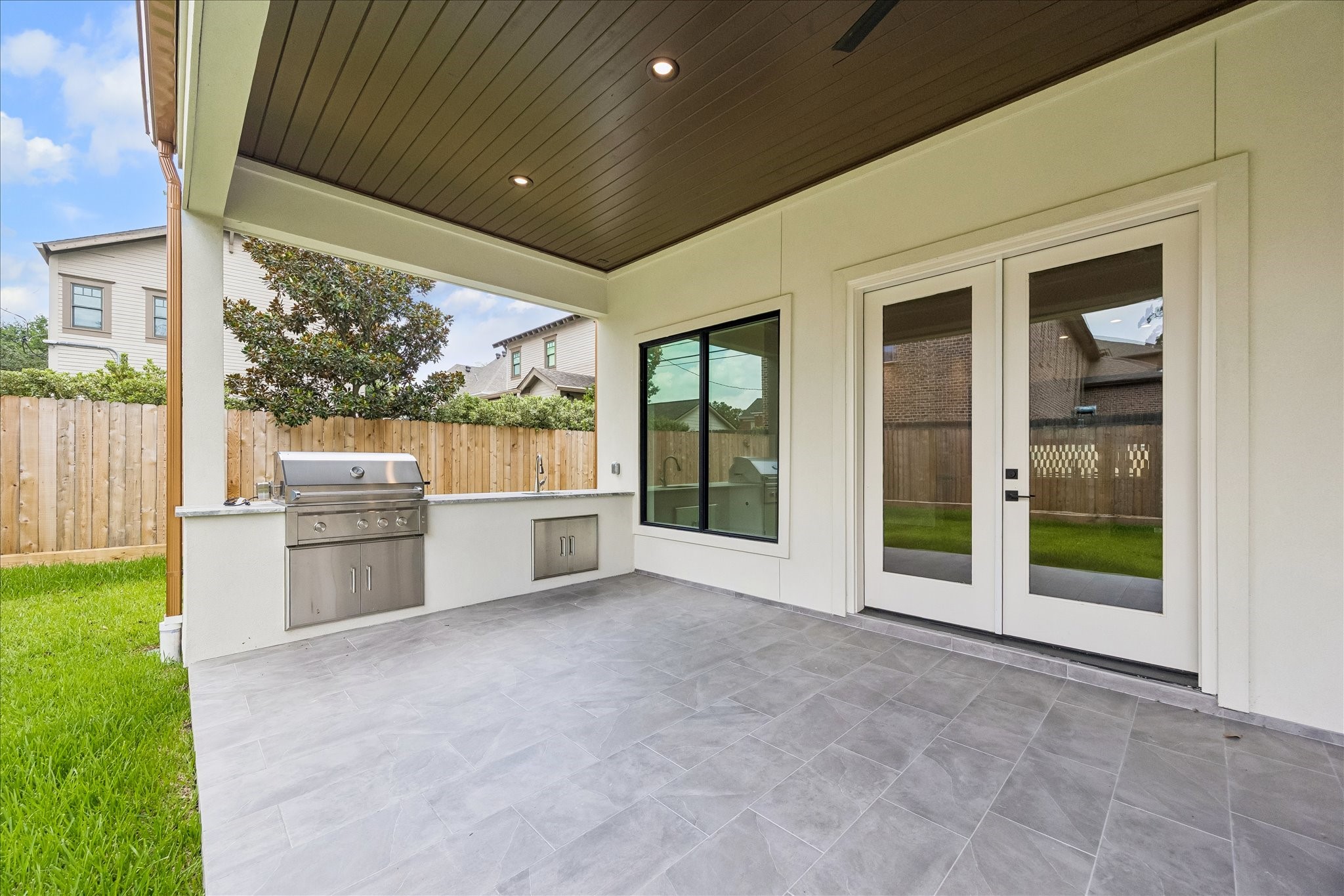 Fire up the built in outdoor kitchen and enjoy year round entertaining beneath the covered patio with a stained wood ceiling and ceiling fan. Direct access from the family room creates a seamless connection between indoor and outdoor living.