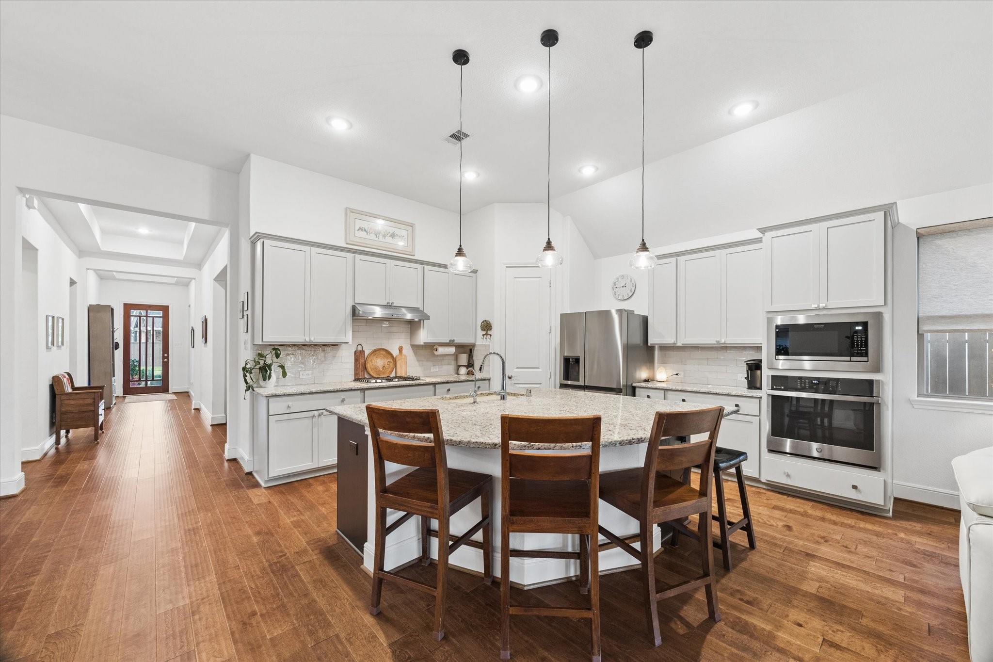The oversized island and chef's kitchen are open to the living and dining rooms