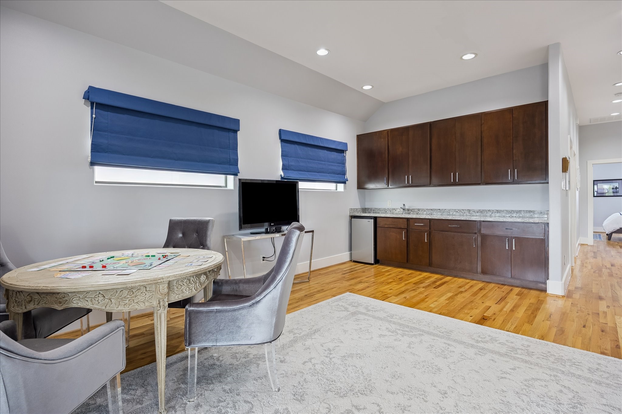 Another view of the GAME ROOM with wet bar, beverage fridge and plenty of storage cabinets to hold all your favorite board games.