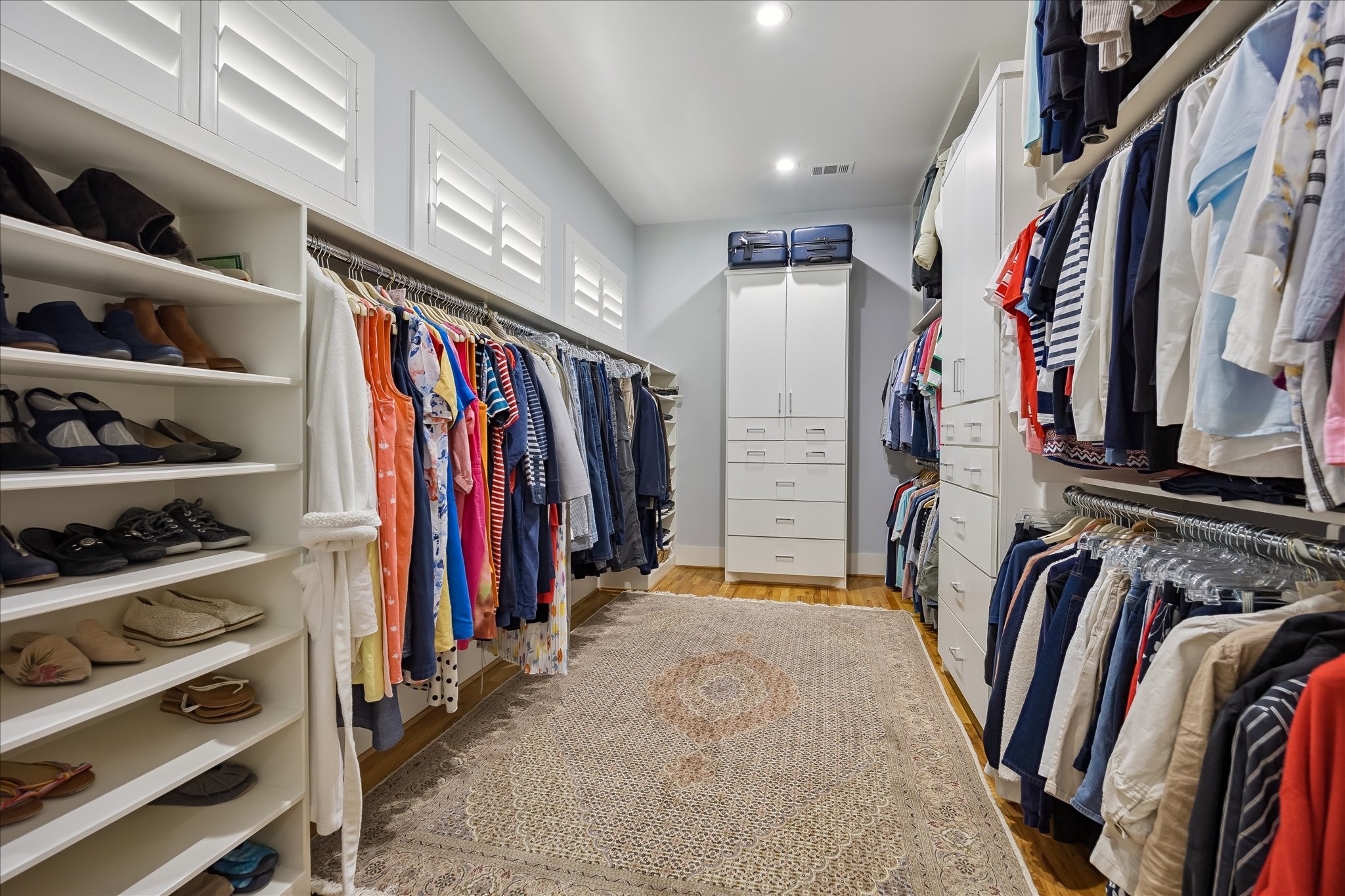 Enormous PRIMARY CLOSET offers a wealth of hanging space along with shoe storage and built in dressers.