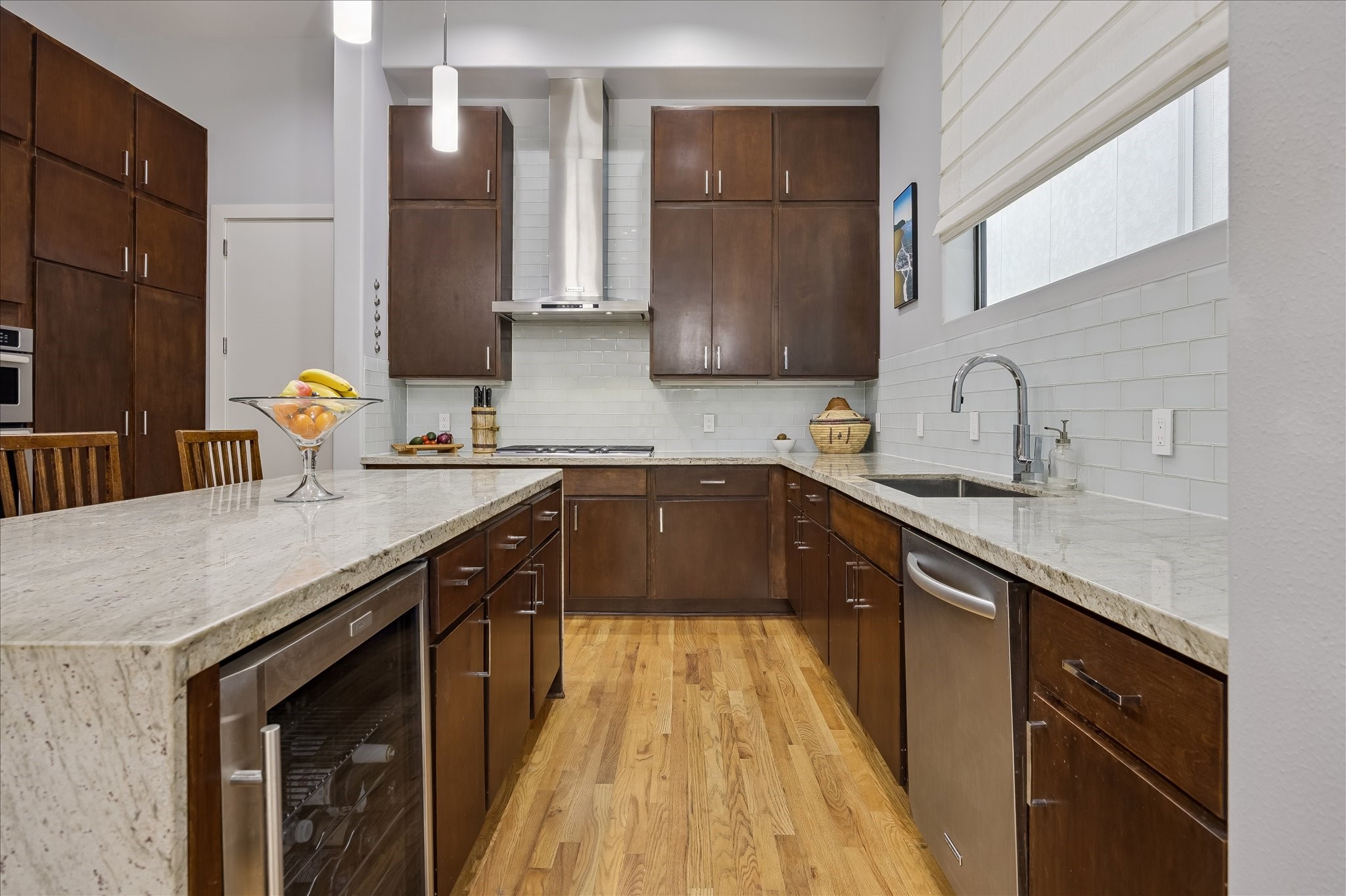 Gourmet chef's KITCHEN with waterfall countertops; an abundance of cabinets and storage space; and a wine / beverage fridge. Gourmet chef's KITCHEN with waterfall countertops; an abundance of cabinets and storage space; and a wine / beverage fridge.