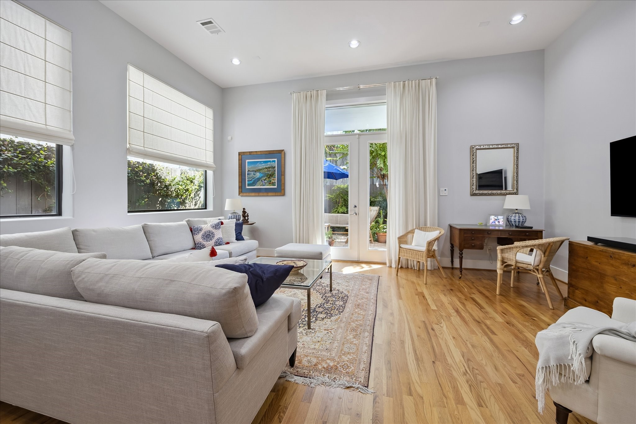 LIVING ROOM is large enough to position furniture in several different ways. The high ceilings of the first floor give the rooms an extra airy and roomy feel. The glass door leads to a private back patio. LIVING ROOM is large enough to position furniture in several different ways. The high ceilings of the first floor give the rooms an extra airy and roomy feel. The glass door leads to a private back patio.