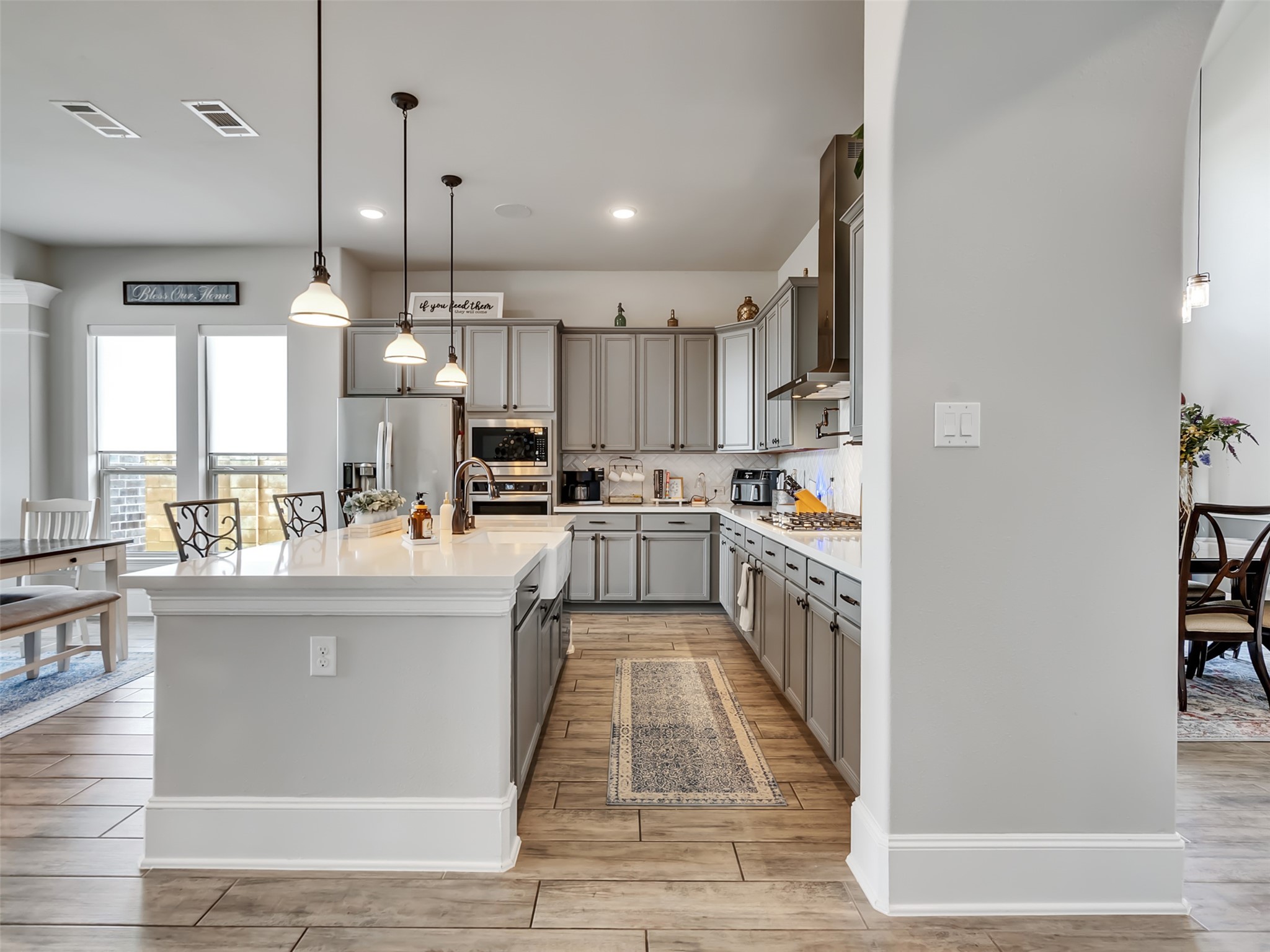 Modern kitchen with sleek gray cabinetry and spacious island with bar seating. Modern kitchen with sleek gray cabinetry and spacious island with bar seating.
