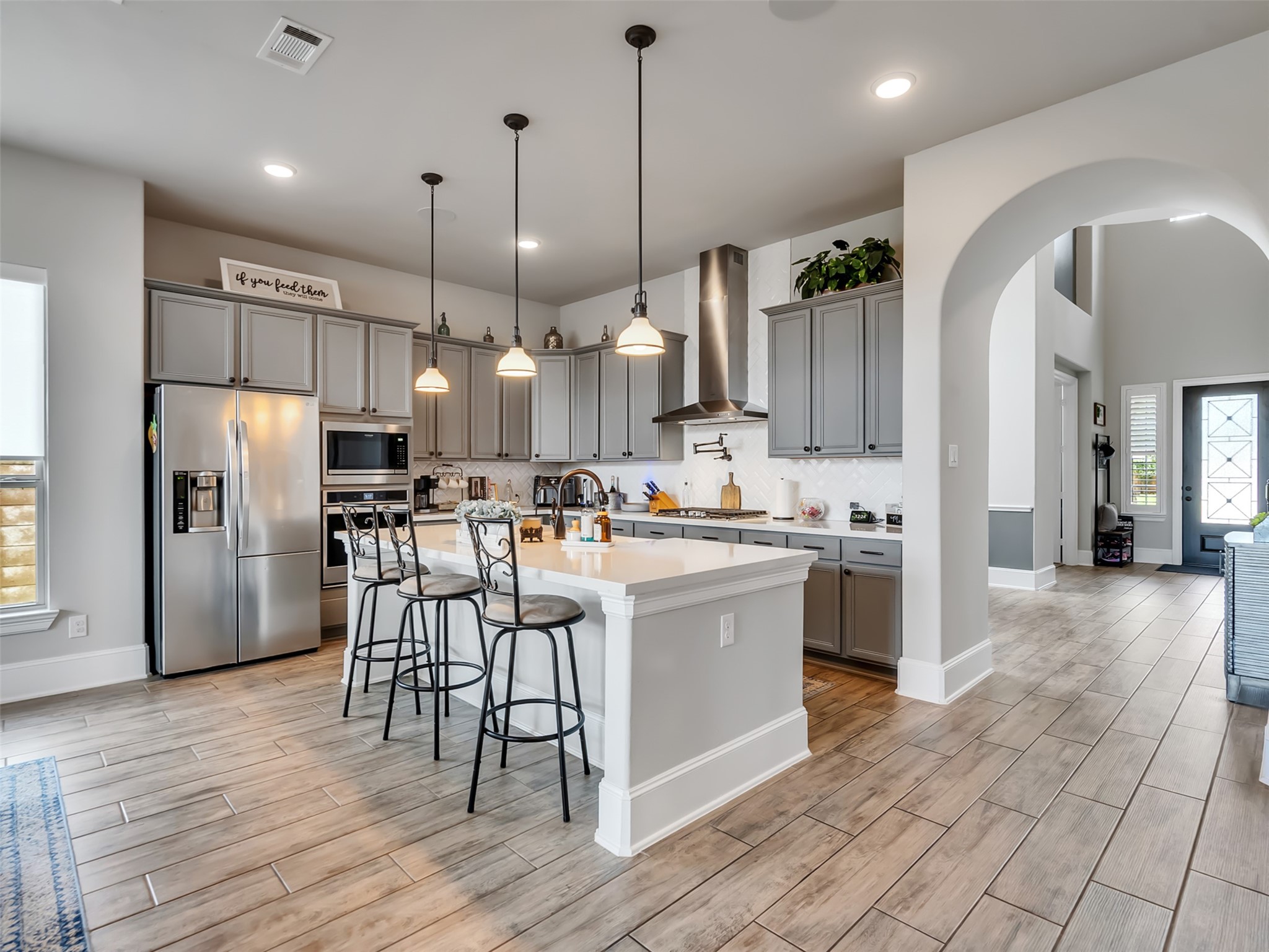 Stainless steel appliances, bar seating, and pendant lighting make this kitchen brilliant.
