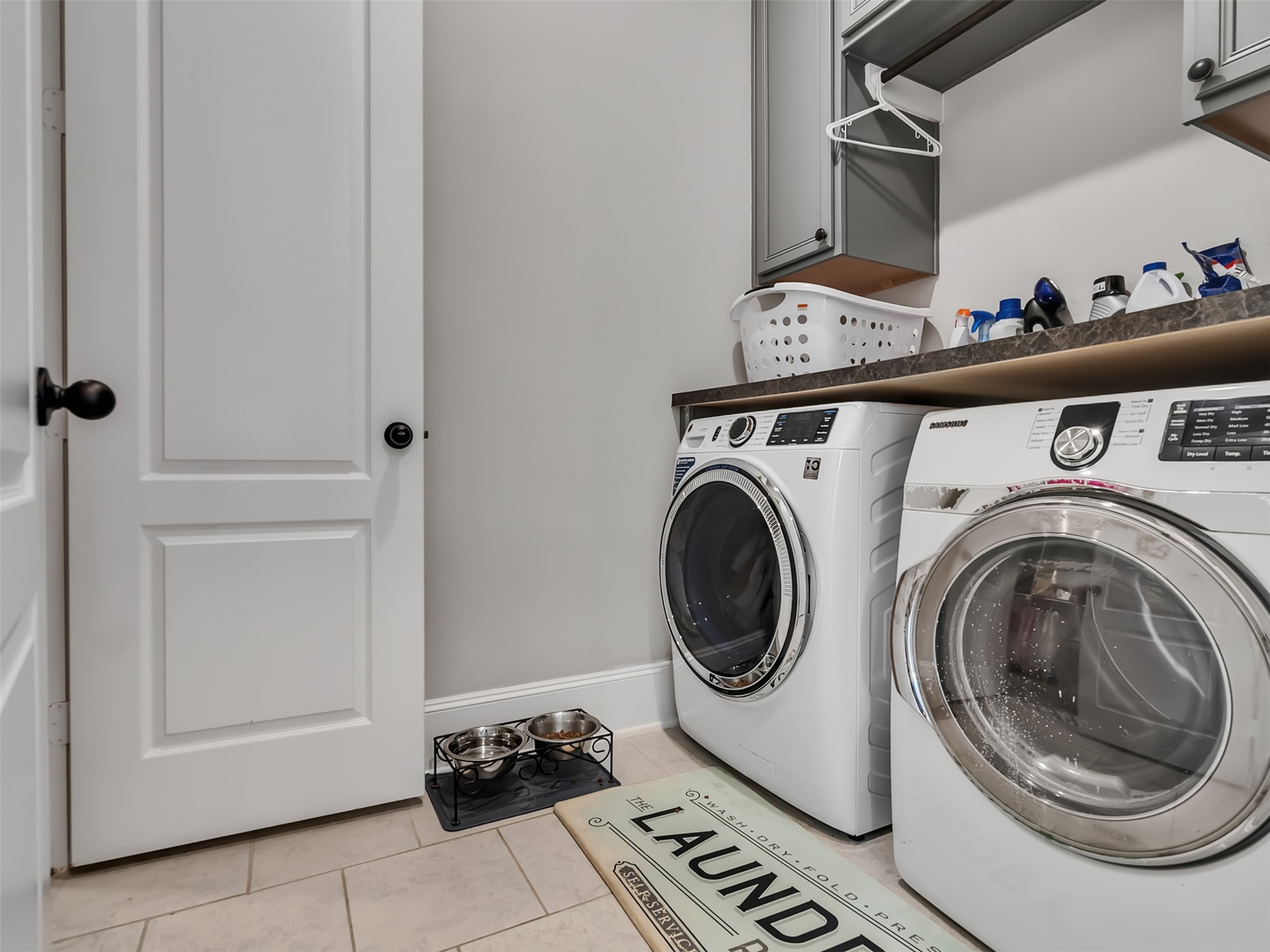 Laundry room area with built-in cabinetry