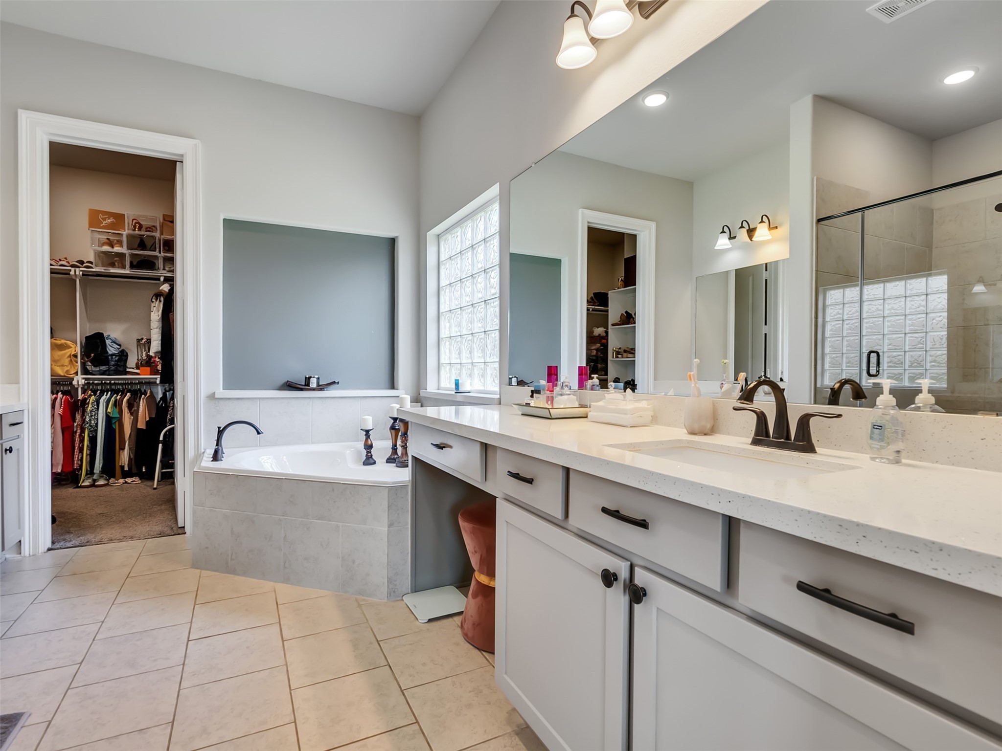 Primary bathroom with dual vanity and makeup area.