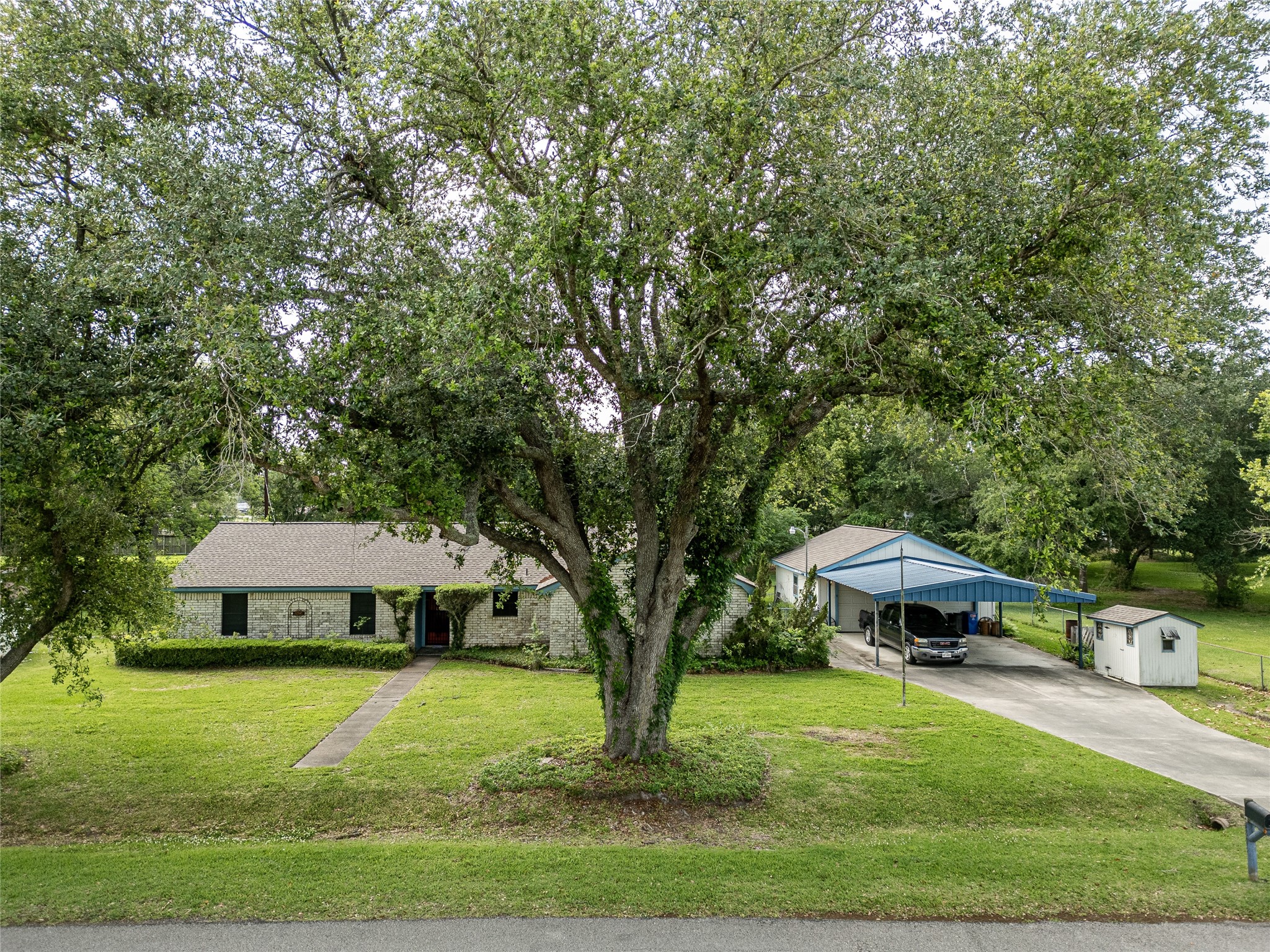 This single-story brick home set on a spacious lot with lots of mature trees. It has a double driveway leading to a covered carport and a detached garage. Serene and inviting, perfect for family living. This single-story brick home set on a spacious lot with lots of mature trees. It has a double driveway leading to a covered carport and a detached garage. Serene and inviting, perfect for family living.
