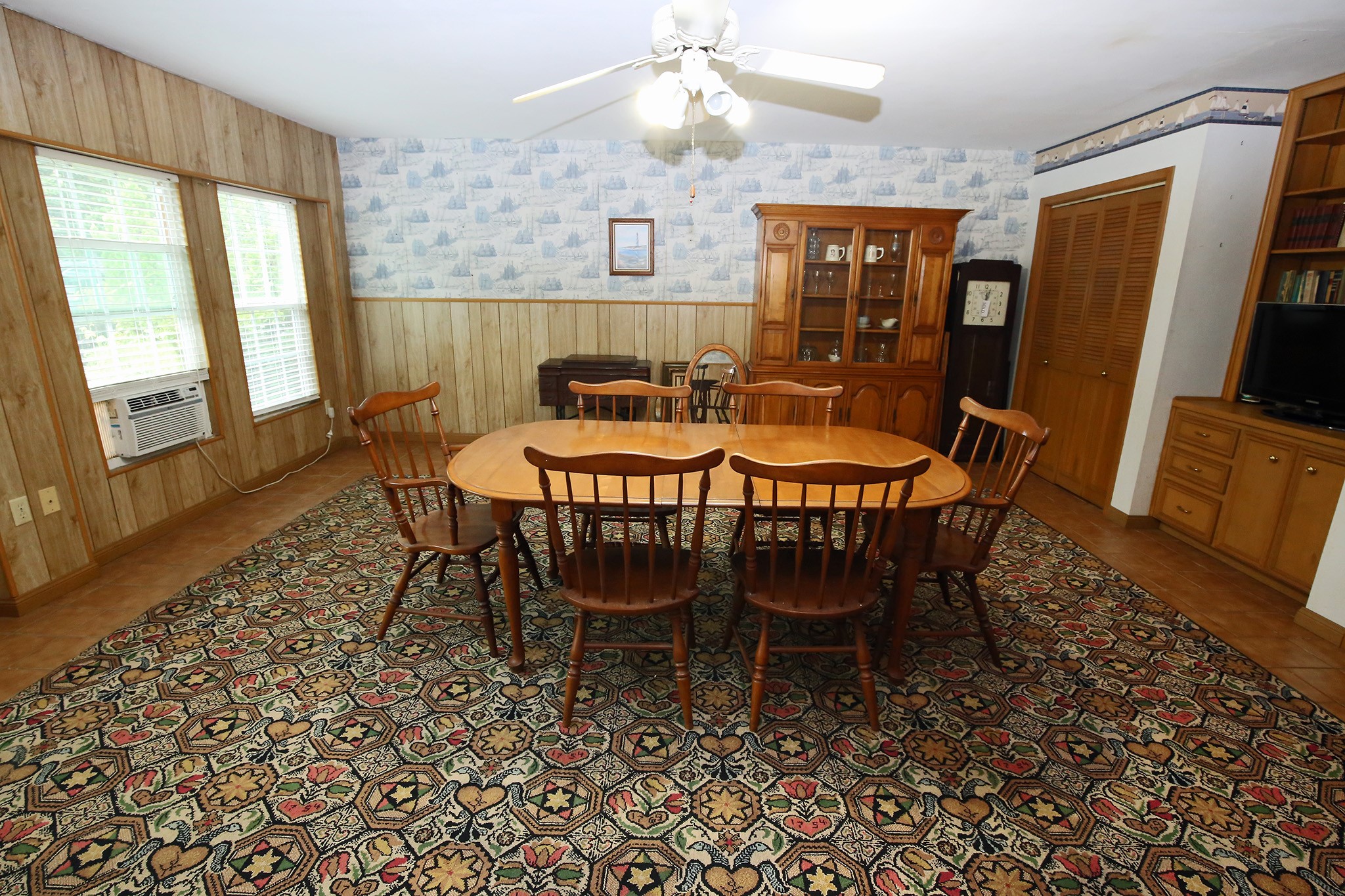 Spacious dining room with natural light, cozy wood paneling, and elegant built-in storage. Perfect for gatherings.