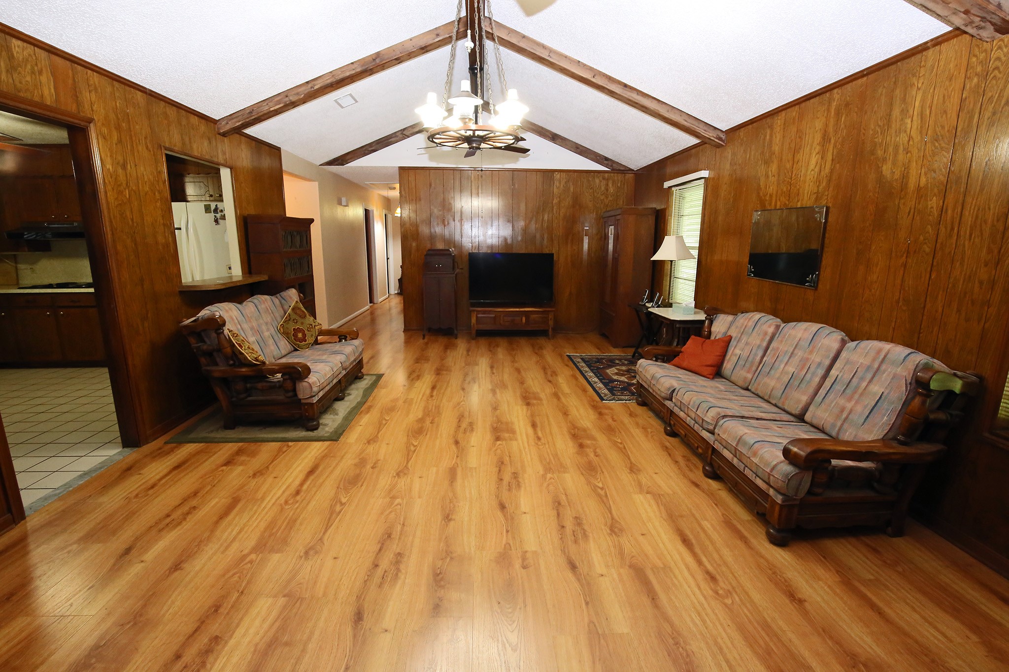 This expansive living room exudes warmth and comfort, perfect for relaxation and entertaining.