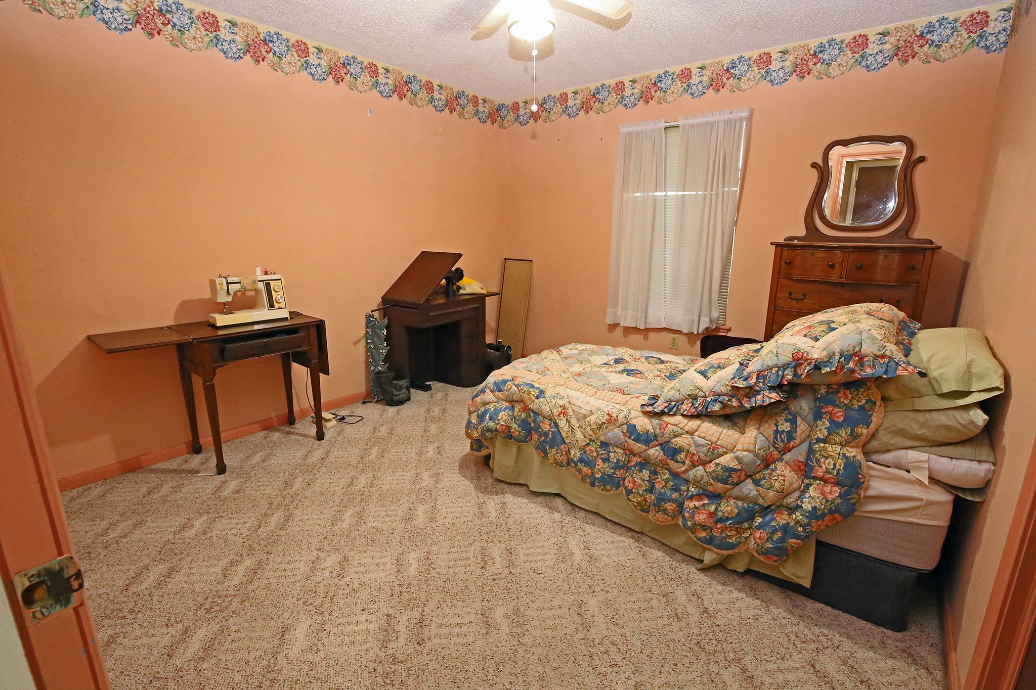 Cozy secondary bedroom with plush carpeting and ample natural light, perfect for guests or a home office.