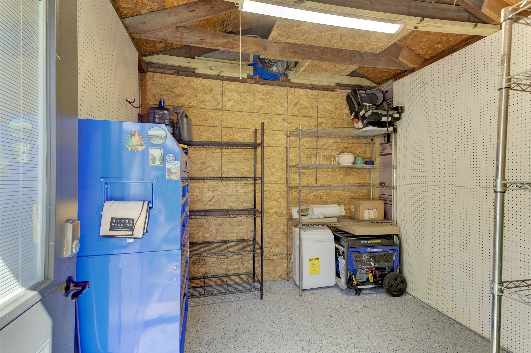 For additional convenience, a spacious and organized shed offers a work space or additional storage.
