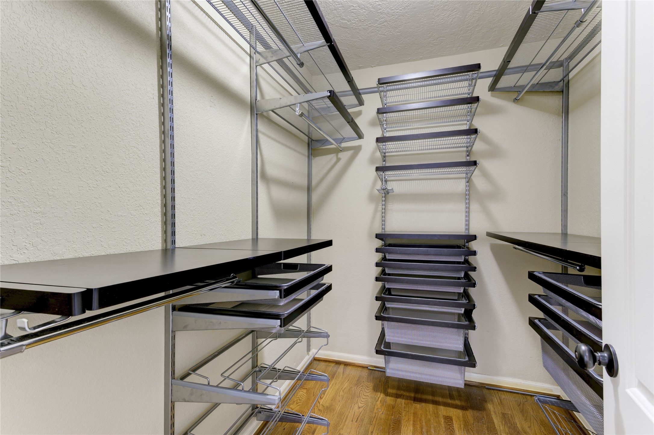 Primary closet with custom shelving system.