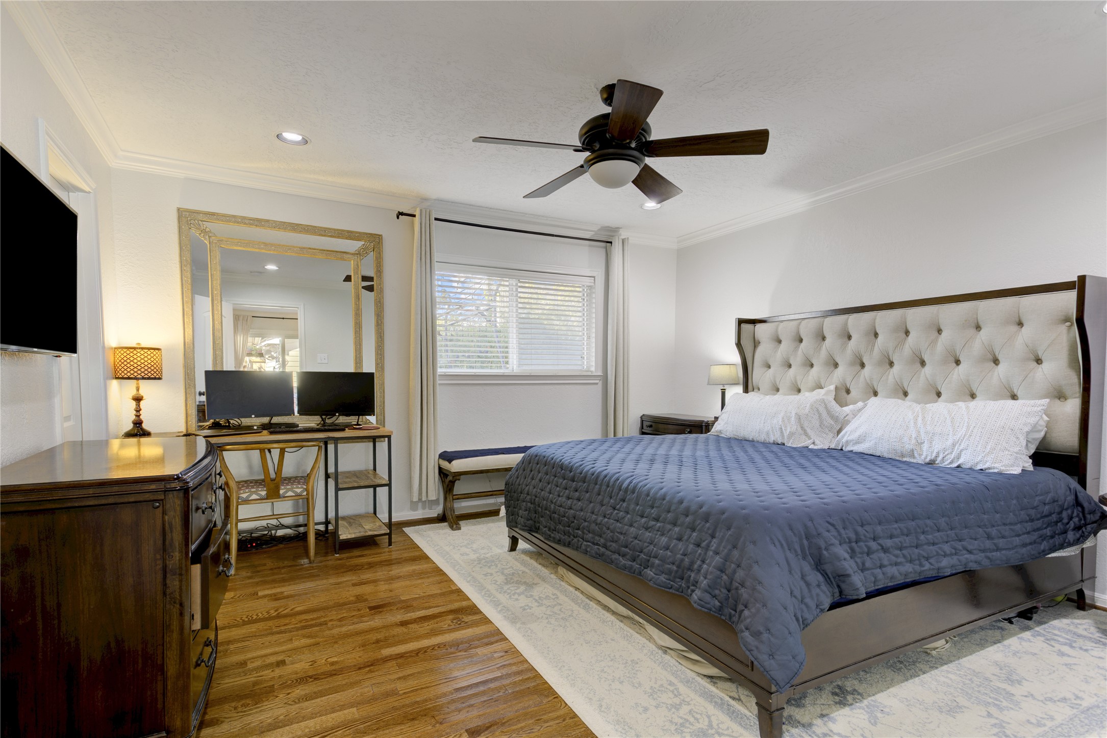 Tucked at the back of the home, the primary suite offers a spacious bedroom, ensuite bathroom, and walk-in closet with a custom storage system.