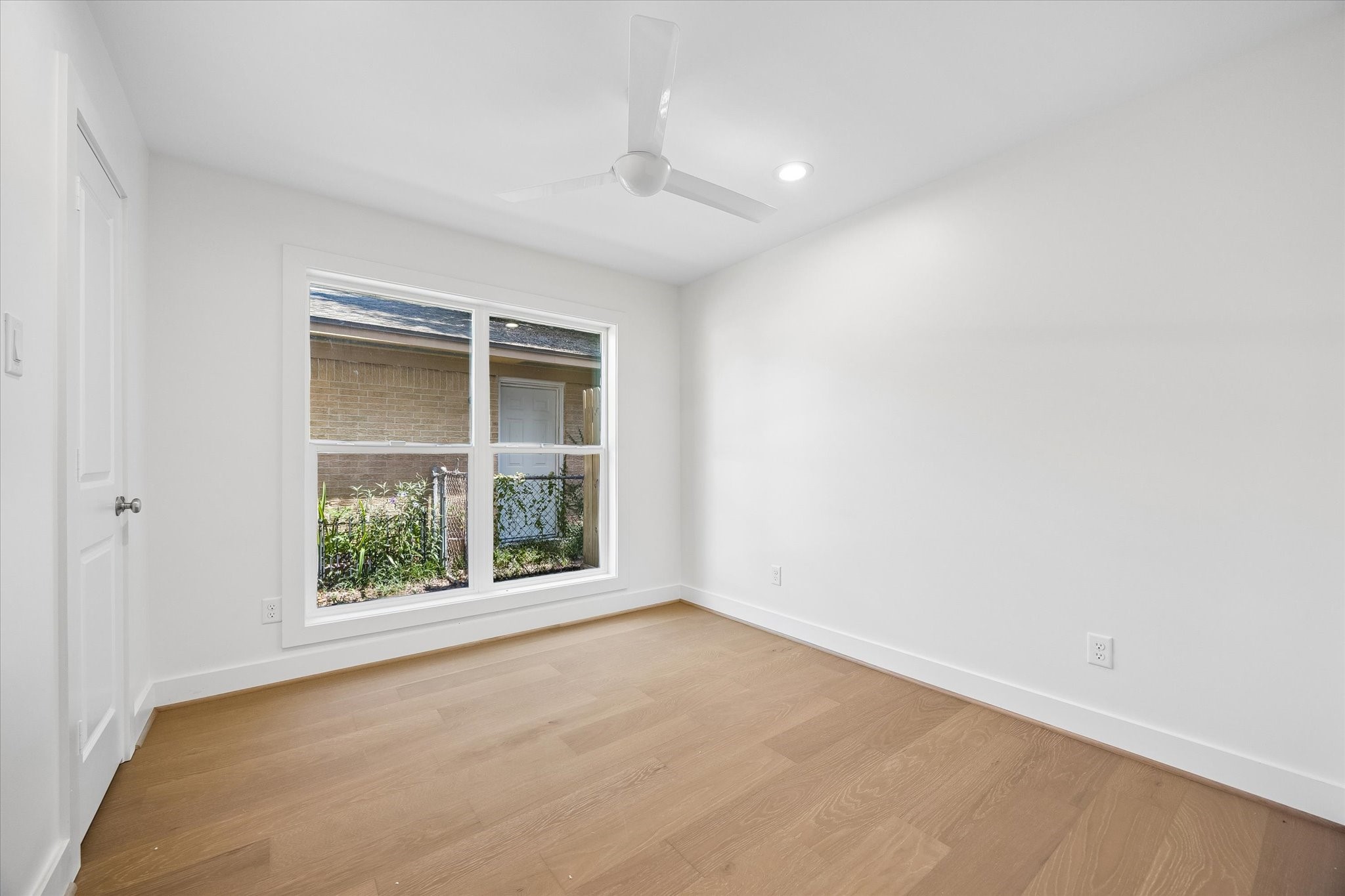 This centrally located bedroom features a large window that brings in ample natural light, creating a bright and airy atmosphere. It's positioned on the right side of the property, providing a quiet and private space.