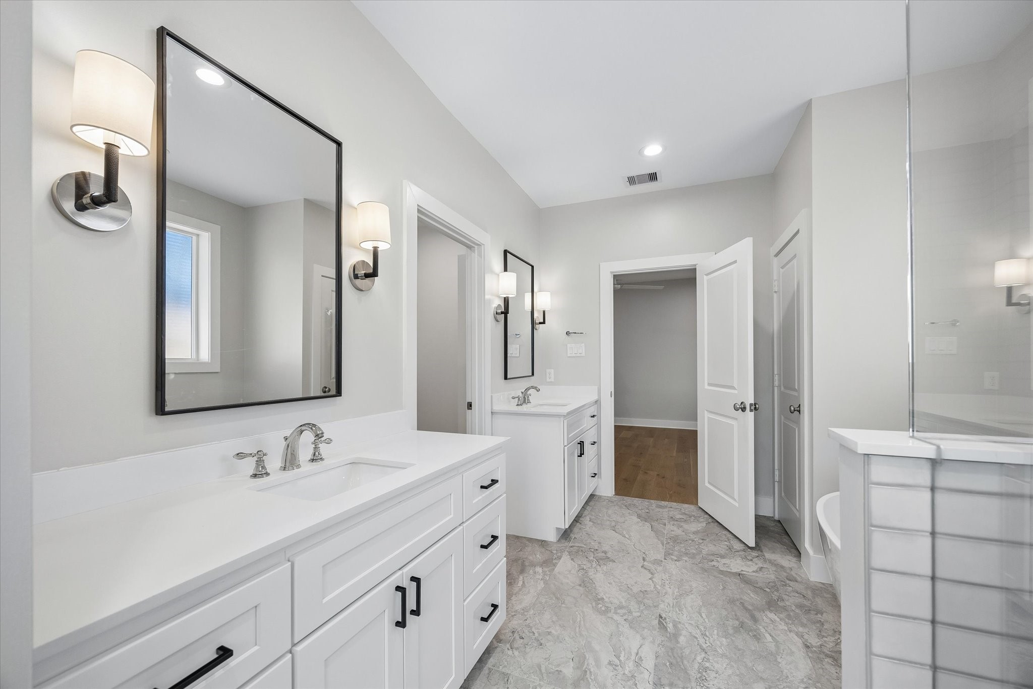 Dual vanities provide ample storage and counter space .