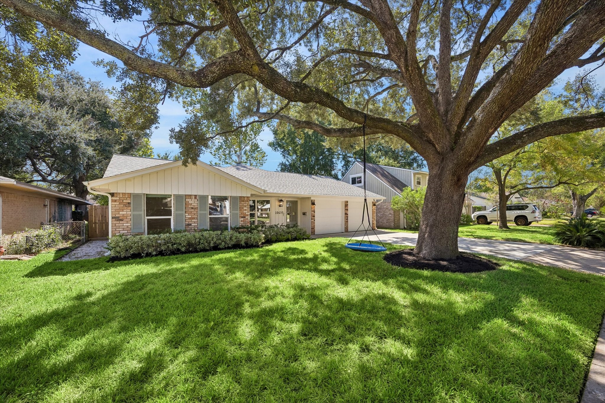 A magnificent mature oak stretches across the front lawn, creating a canopy of shade and giving the property the established character buyers love in Spring Branch. The wide front yard offers plenty of green space while framing the home beautifully from the street.