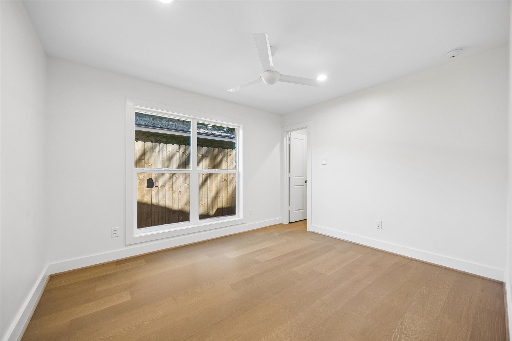 This bright and airy bedroom offers a peaceful retreat with an oversized window allowing for plenty of natural light. The room is a blank canvas, ready for your personal touch to transform it into a cozy and inviting space.