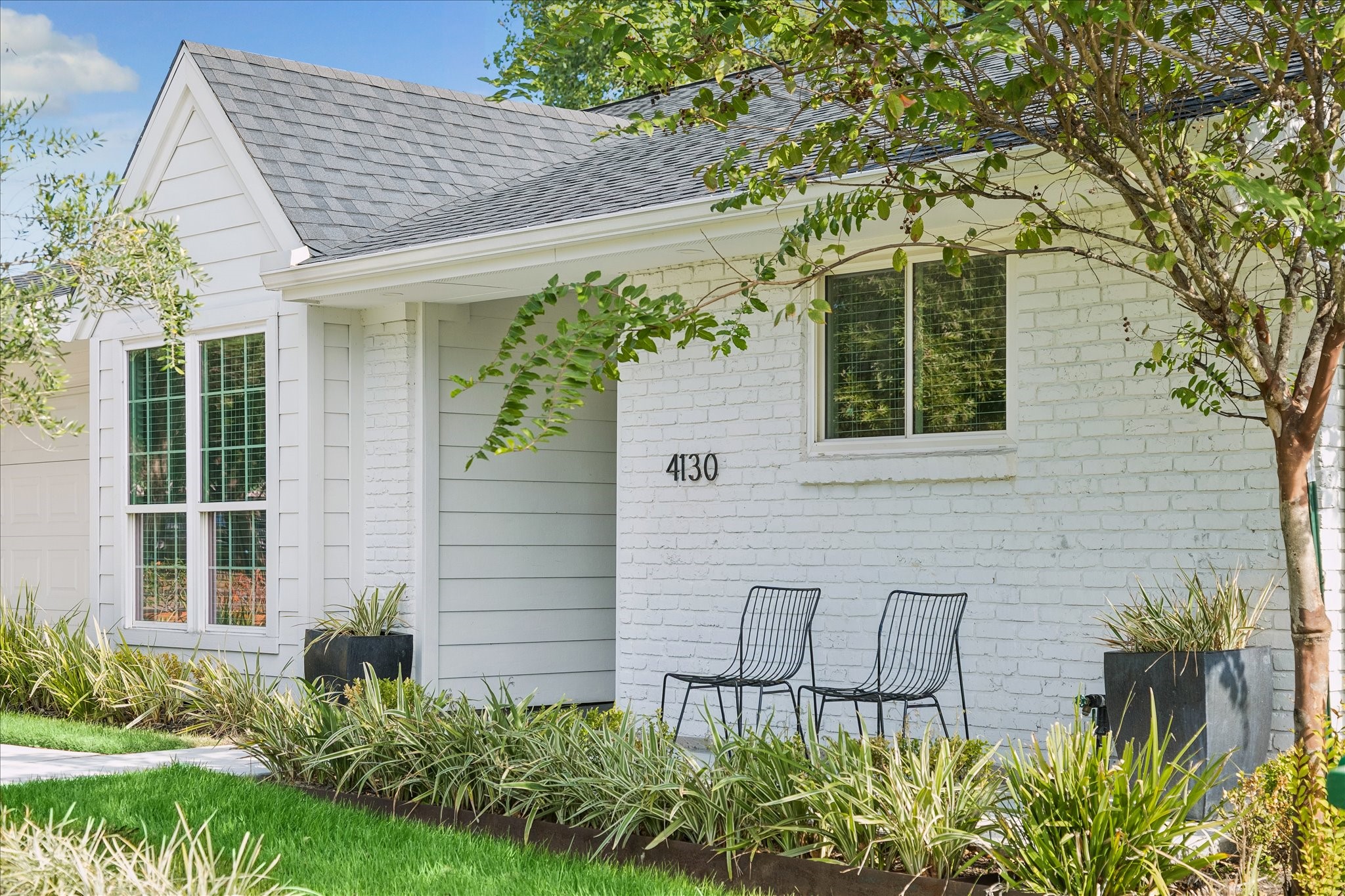Welcome to 4130 Costa Rice, where classic architecture, crisp white brick, and beautifully maintained landscaping create an inviting first impression.