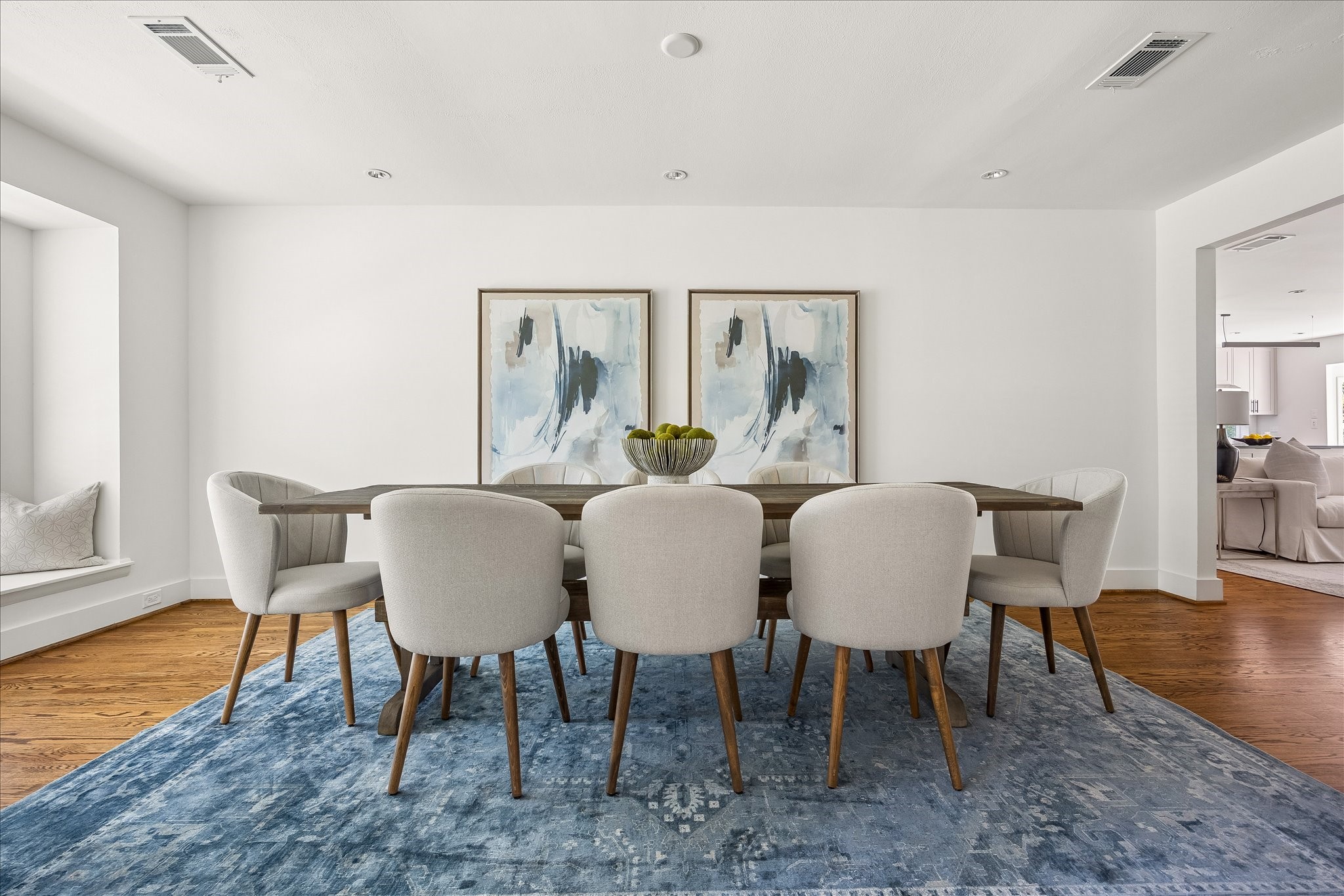 A charming window seat adds architectural interest, while an open passage connects the dining room to the home's main living spaces. A charming window seat adds architectural interest, while an open passage connects the dining room to the home's main living spaces.