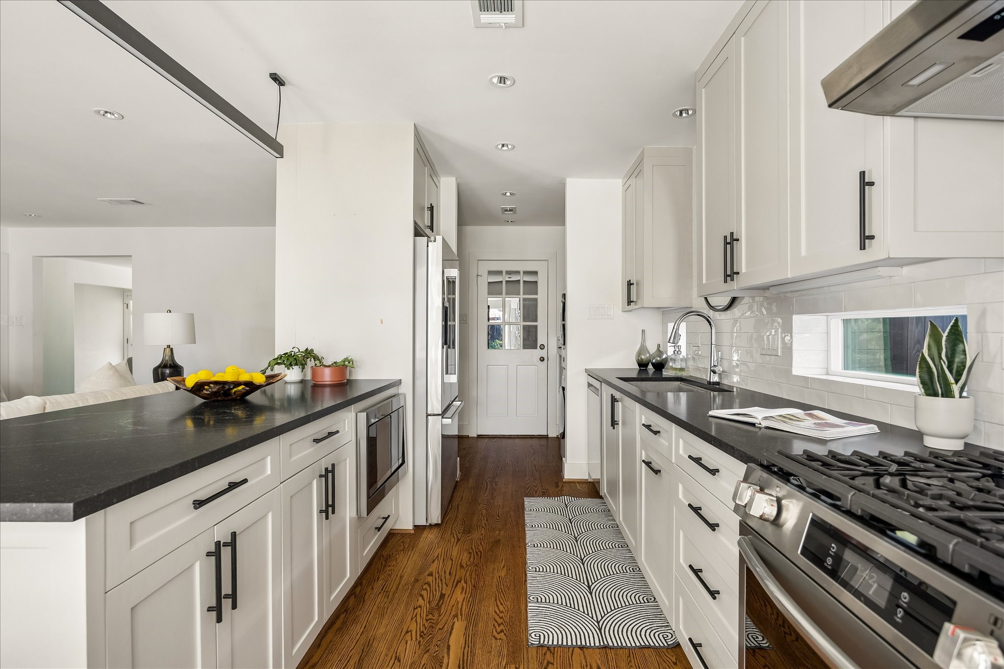Clean-lined cabinetry, generous counter space, and warm hardwood flooring create a seamless balance of style and everyday functionality.