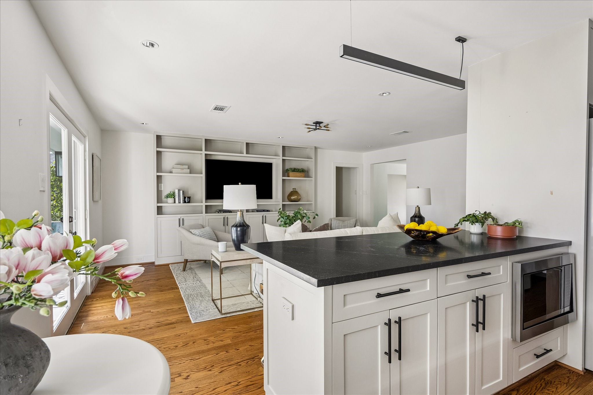 An open sightline from the kitchen into the family room highlights the home's easy, connected layout.