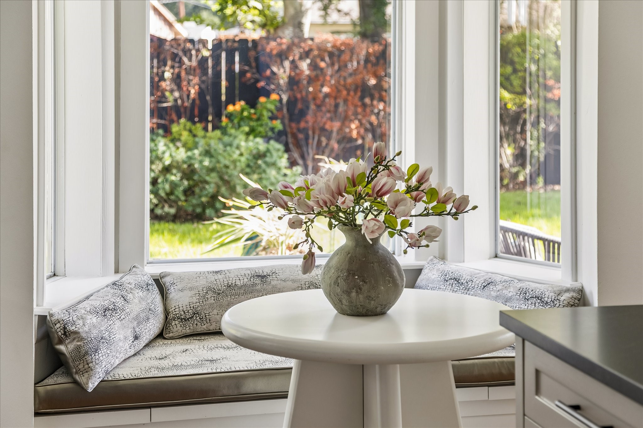 Wrapped in windows, the charming breakfast nook offers a lovely view of the beautifully landscaped backyard.