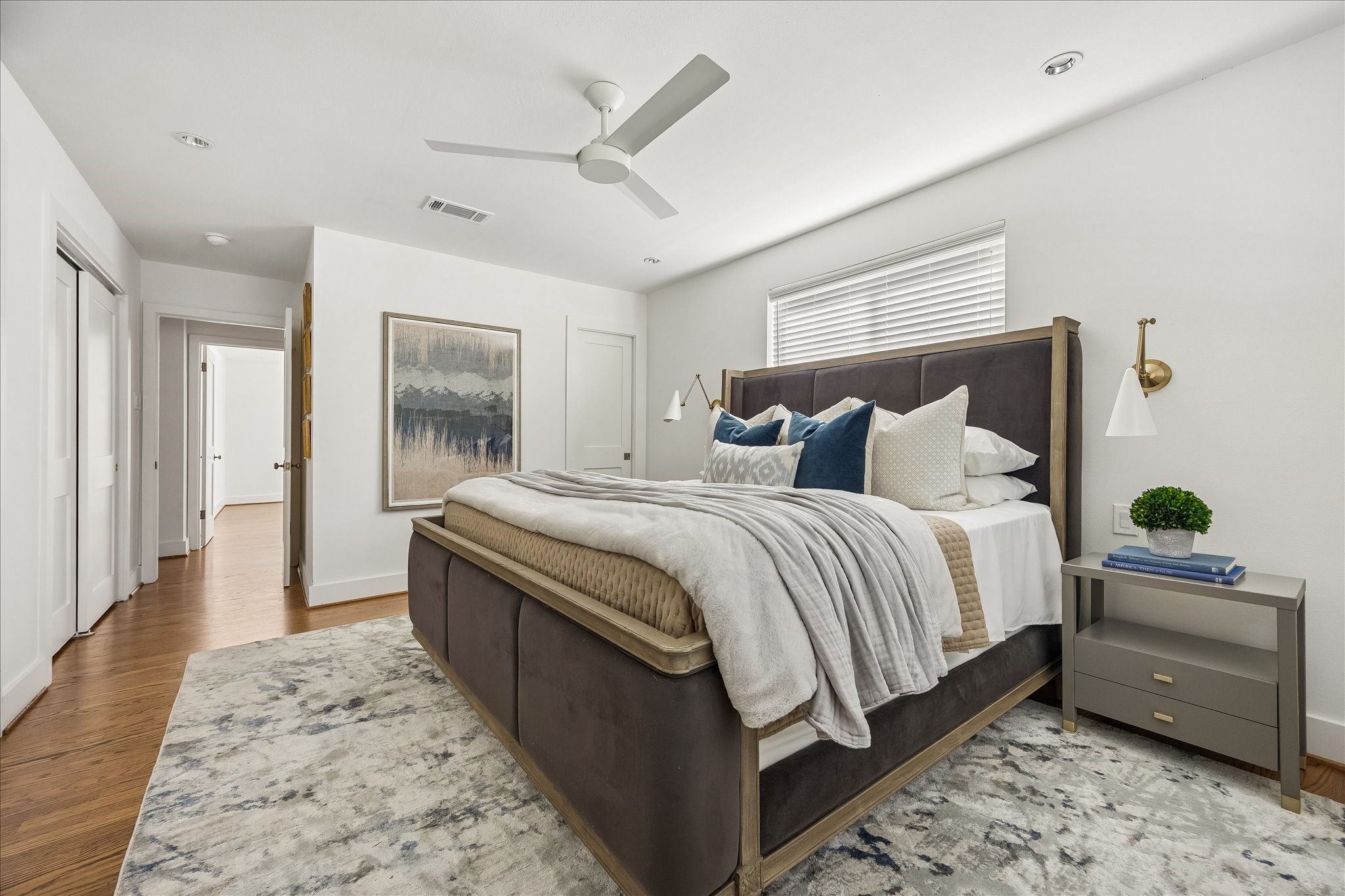 From another angle, the spacious primary bedroom reveals its generous proportions and convenient closet storage.