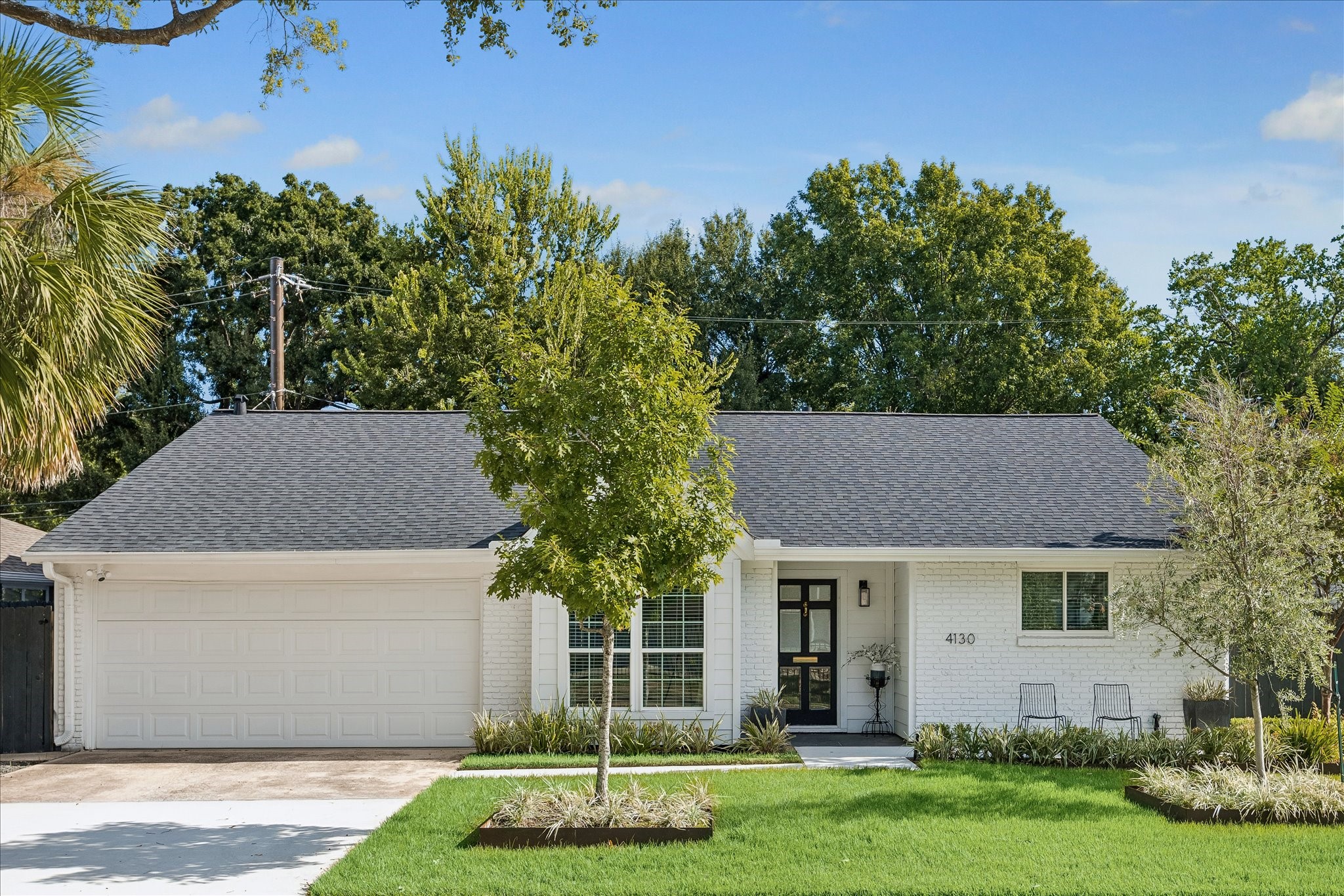 Another look at the home's classic architecture, crisp white brick, and beautifully maintained landscaping, all contributing to an inviting and memorable first impression.