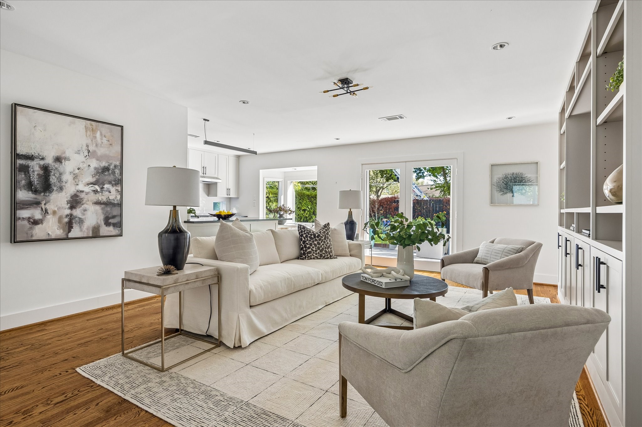 French doors invite the outdoors in, framing lovely backyard views from the light-filled family room.