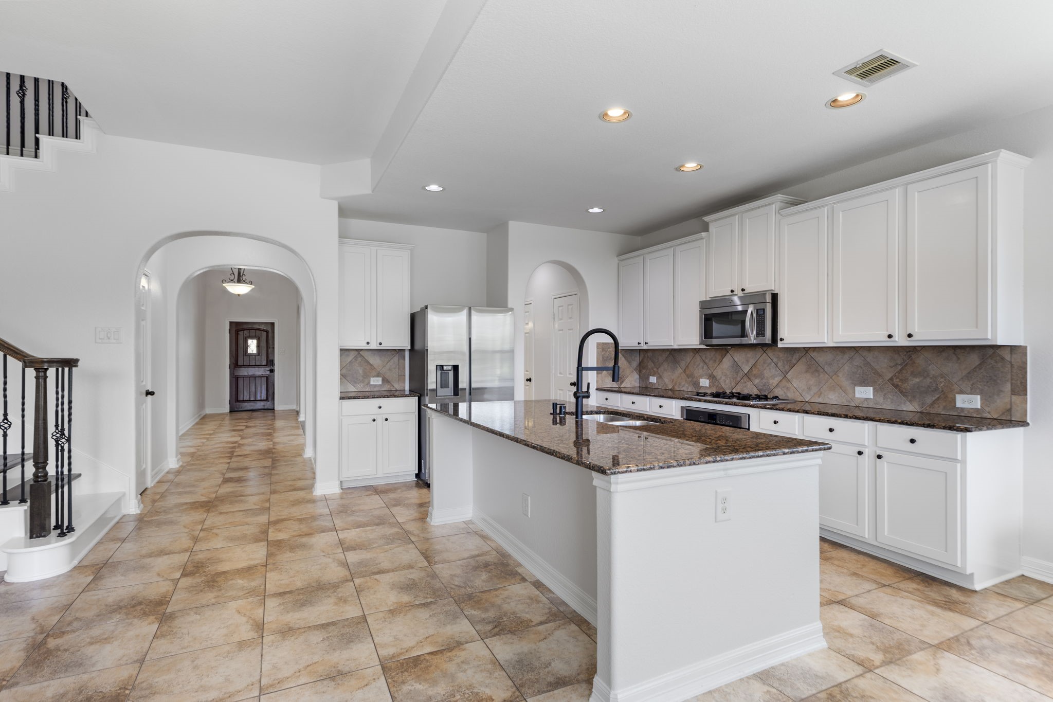 Spacious island with sink and dishwasher.