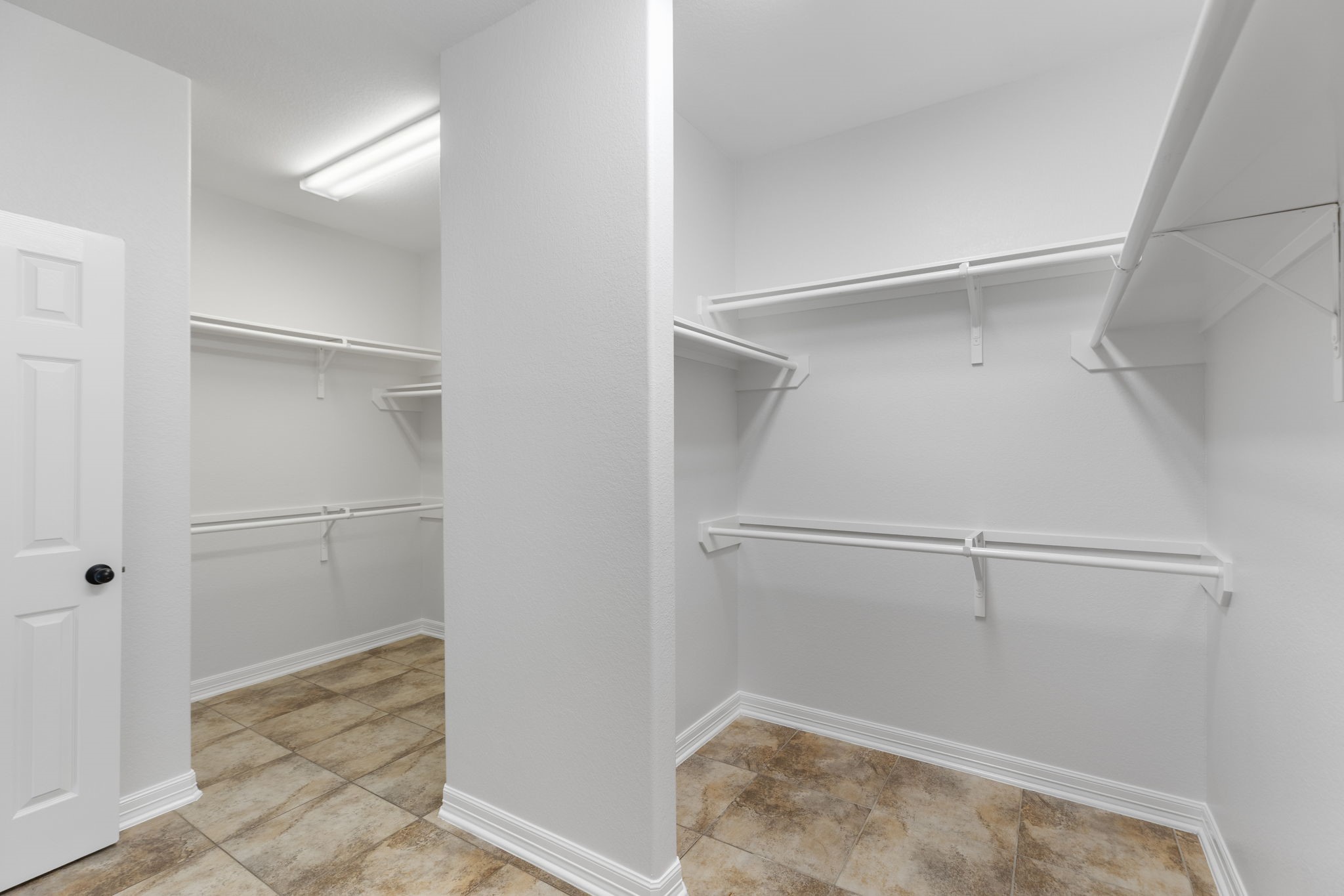 Primary walk in closet is very large and separated into two sections.