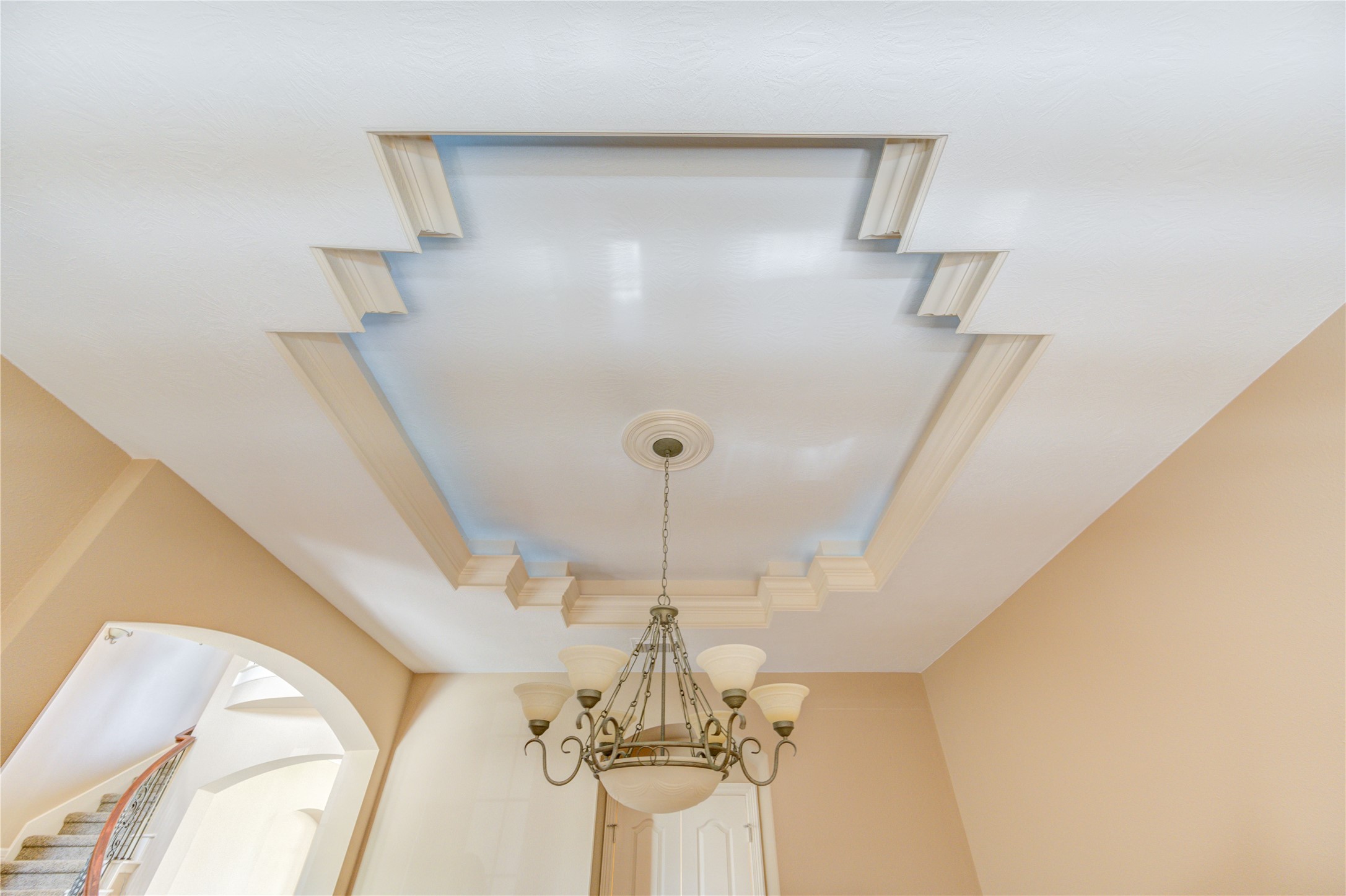 Formal dining room featuring a detailed tray ceiling.