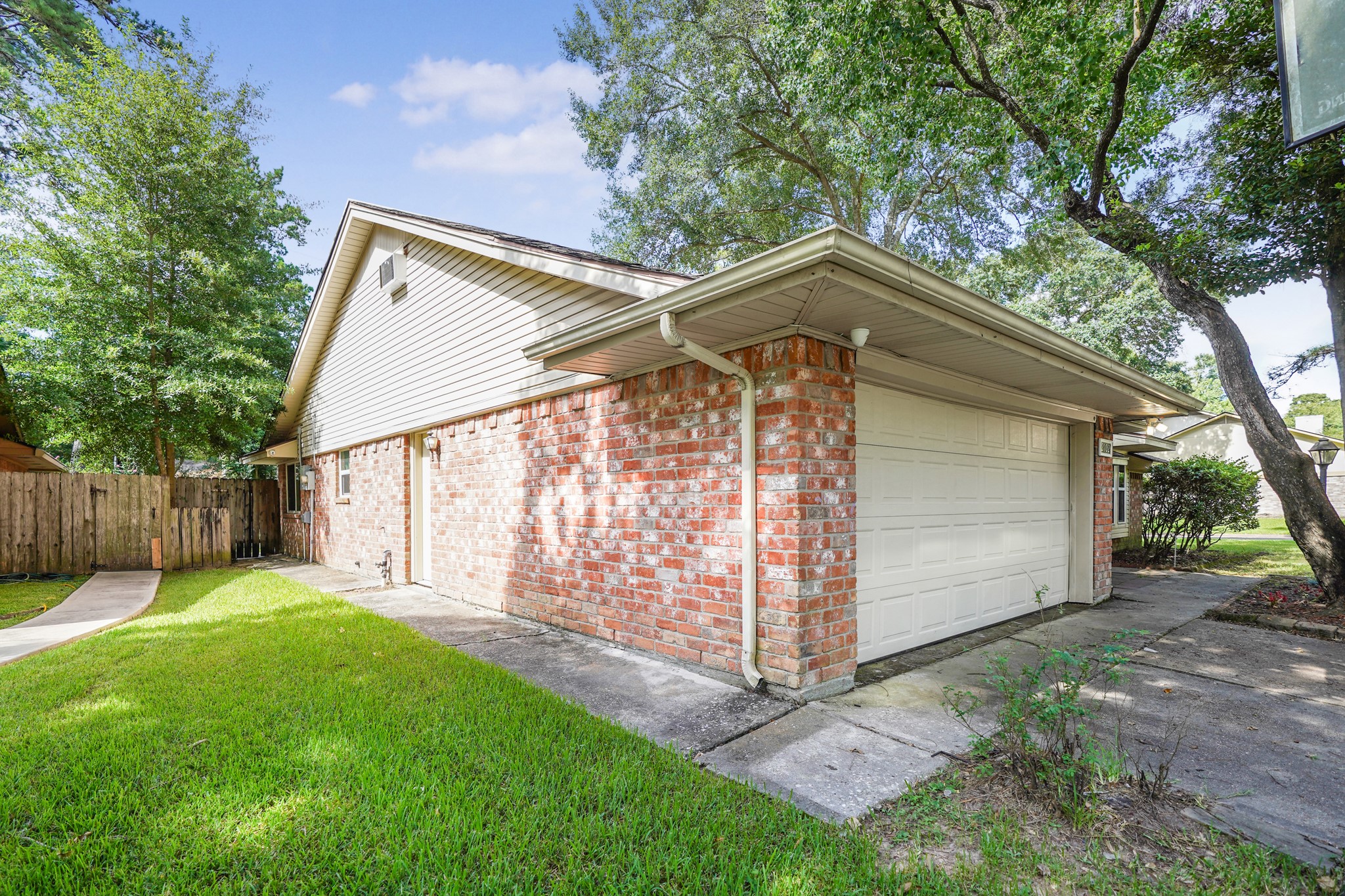 Side of the home with a view of the new garage door.