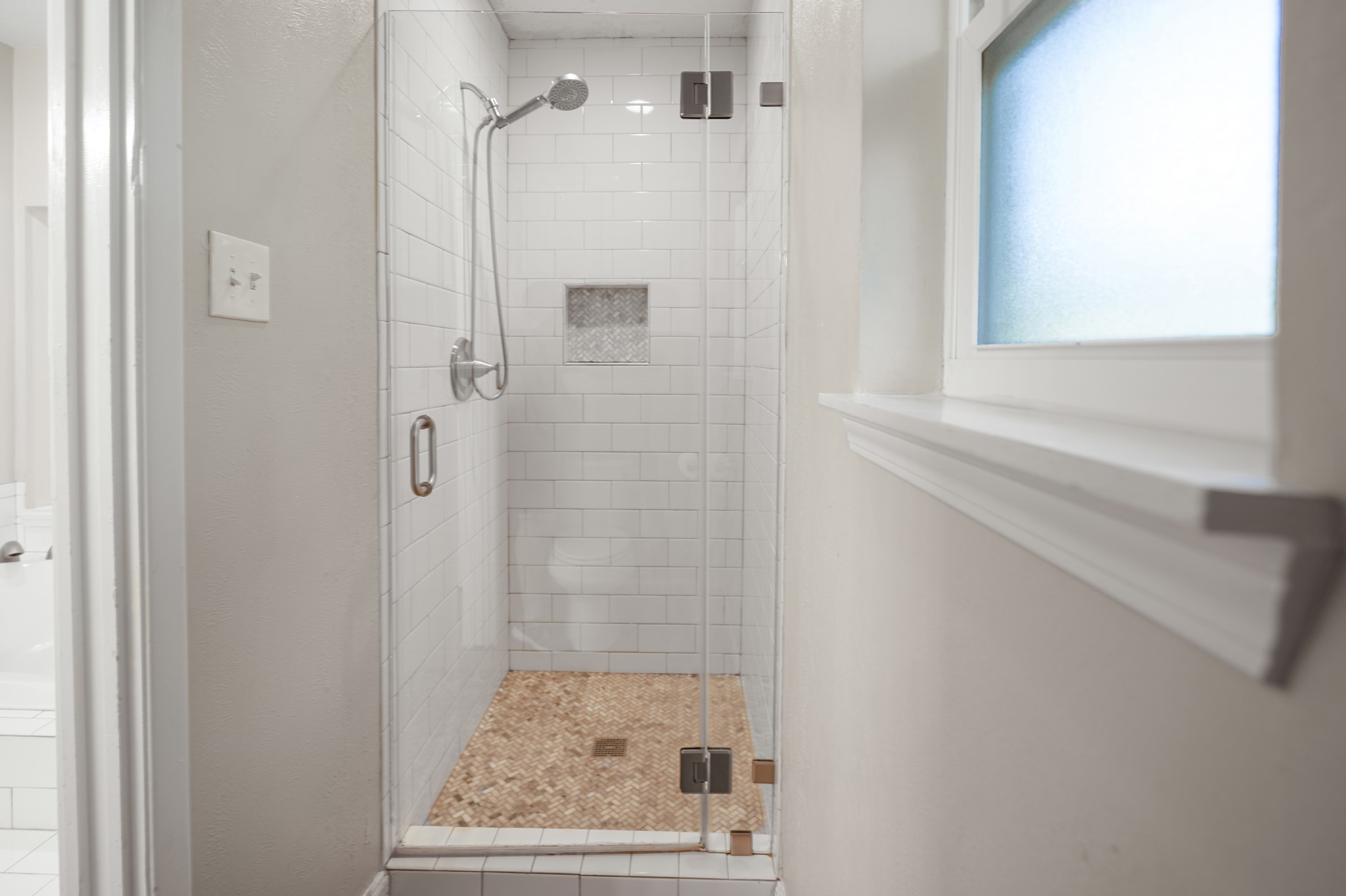 The primary suite with a separate shower and tub.