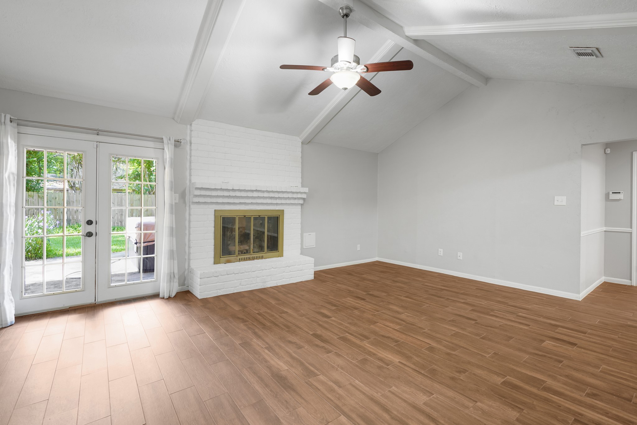 Inviting gas log fireplace and French doors opens to the backyard.