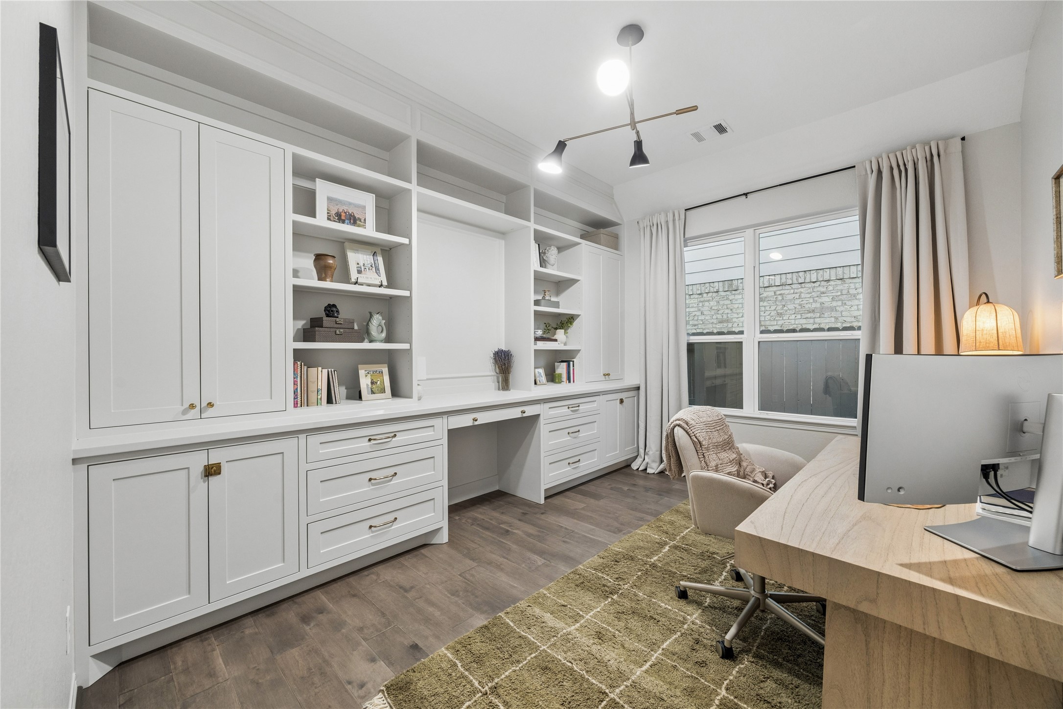 14x10 first floor office with custom site built cabinetry, desk, drawers & open shelves. updated designer LED lighting. window treatments.