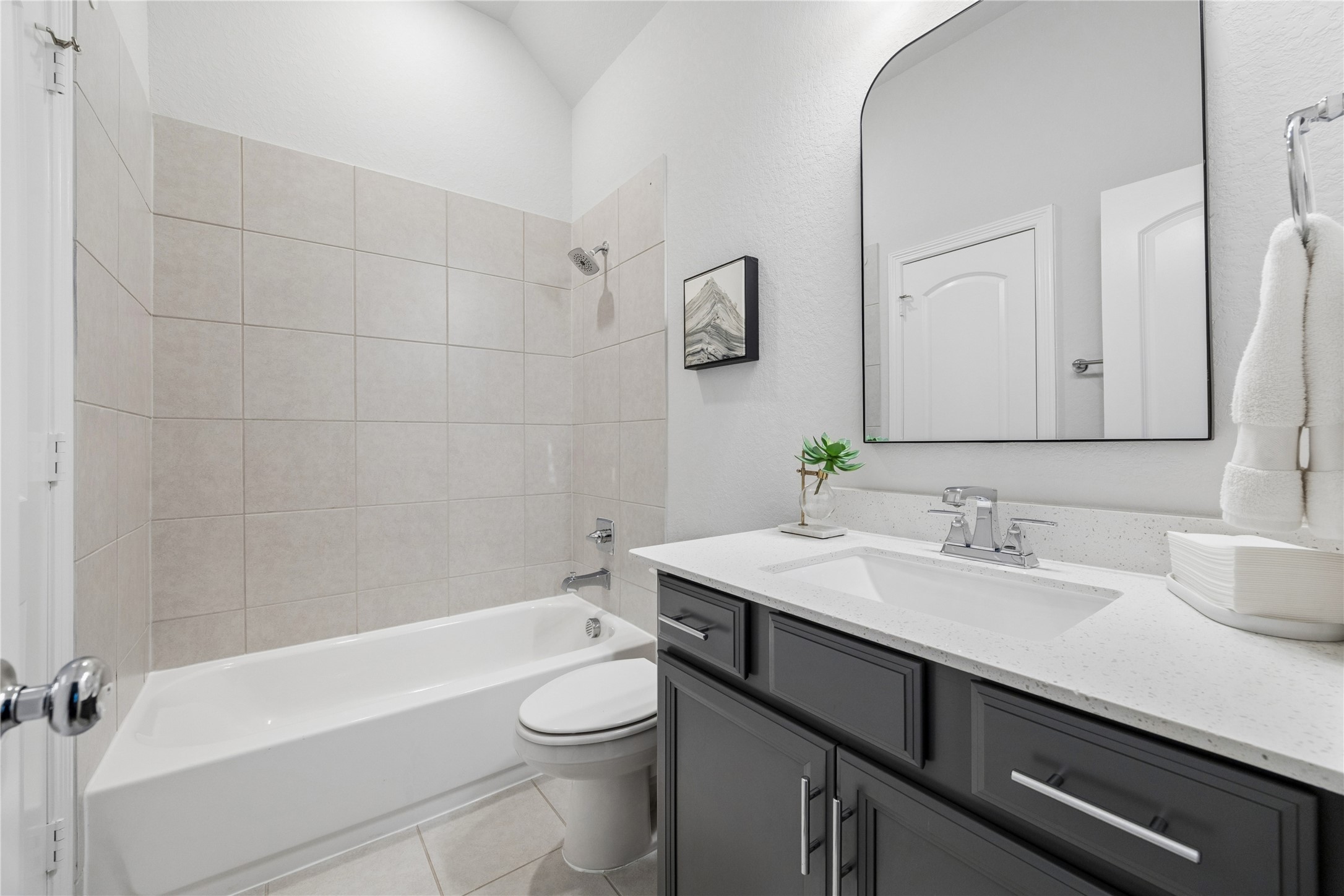 1st floor shared bathroom, quartz counters, porcelain tile.