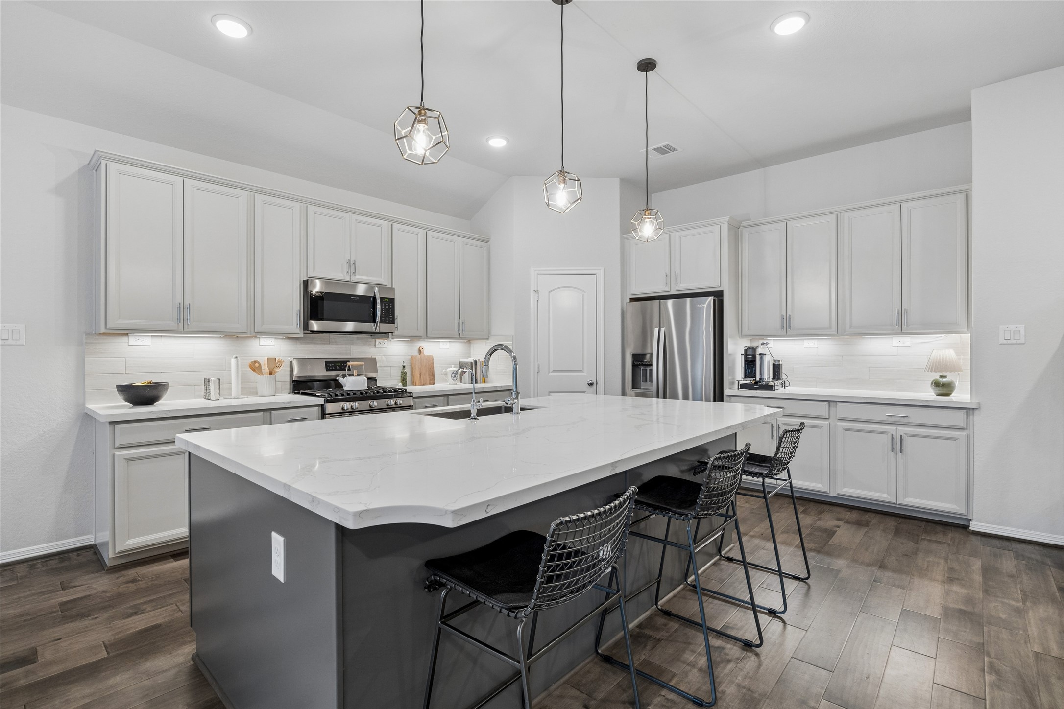 Quarts countertops, designer accent lighting, engineered wood floors, LED lighting.