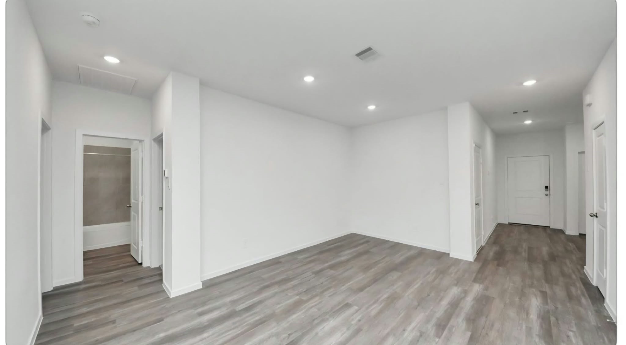 Generously sized primary suite with natural light and a ceiling fan.