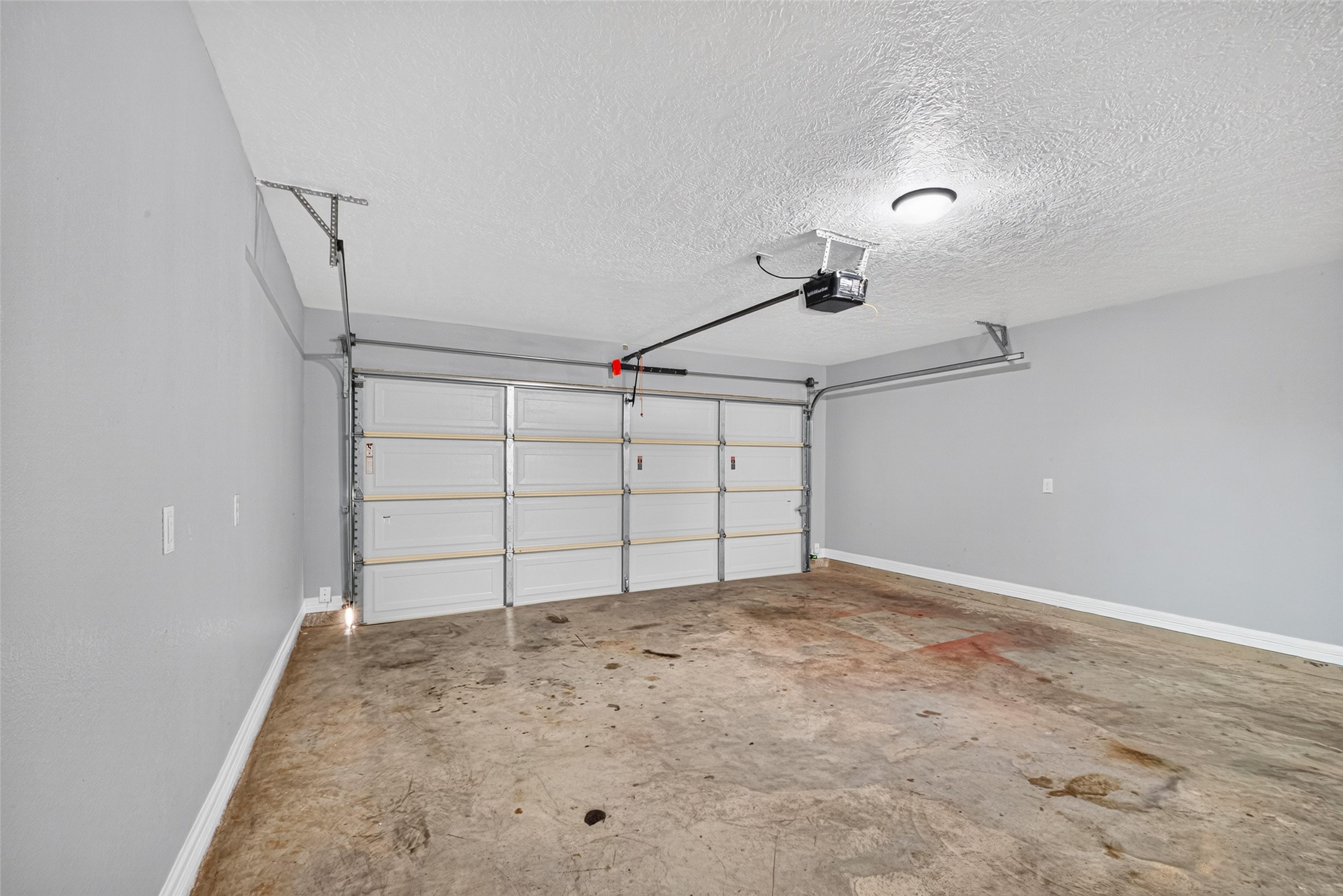 Spacious two-car garage with an automatic door opener.
