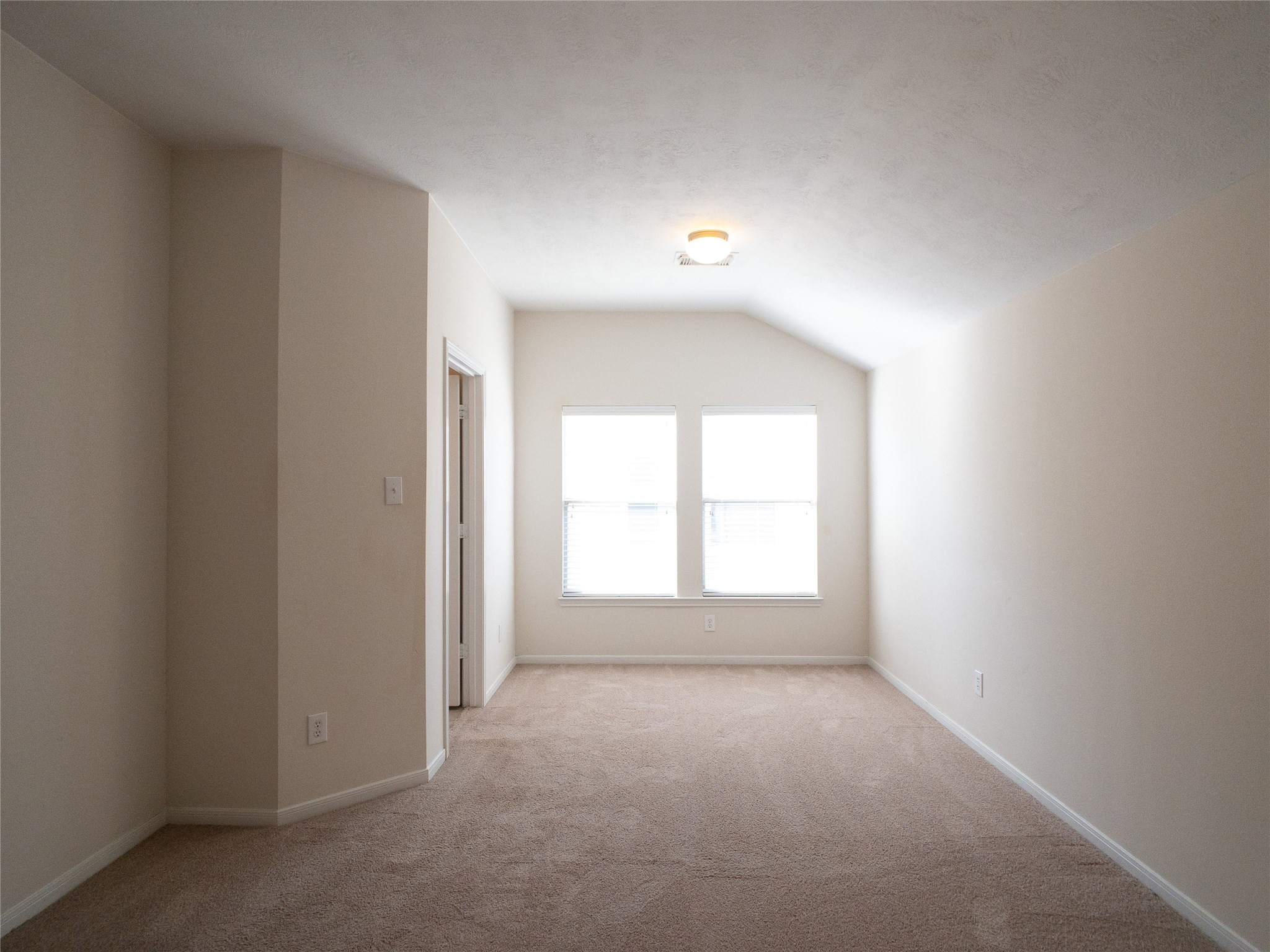 primary bedroom with high, vaulted ceiling