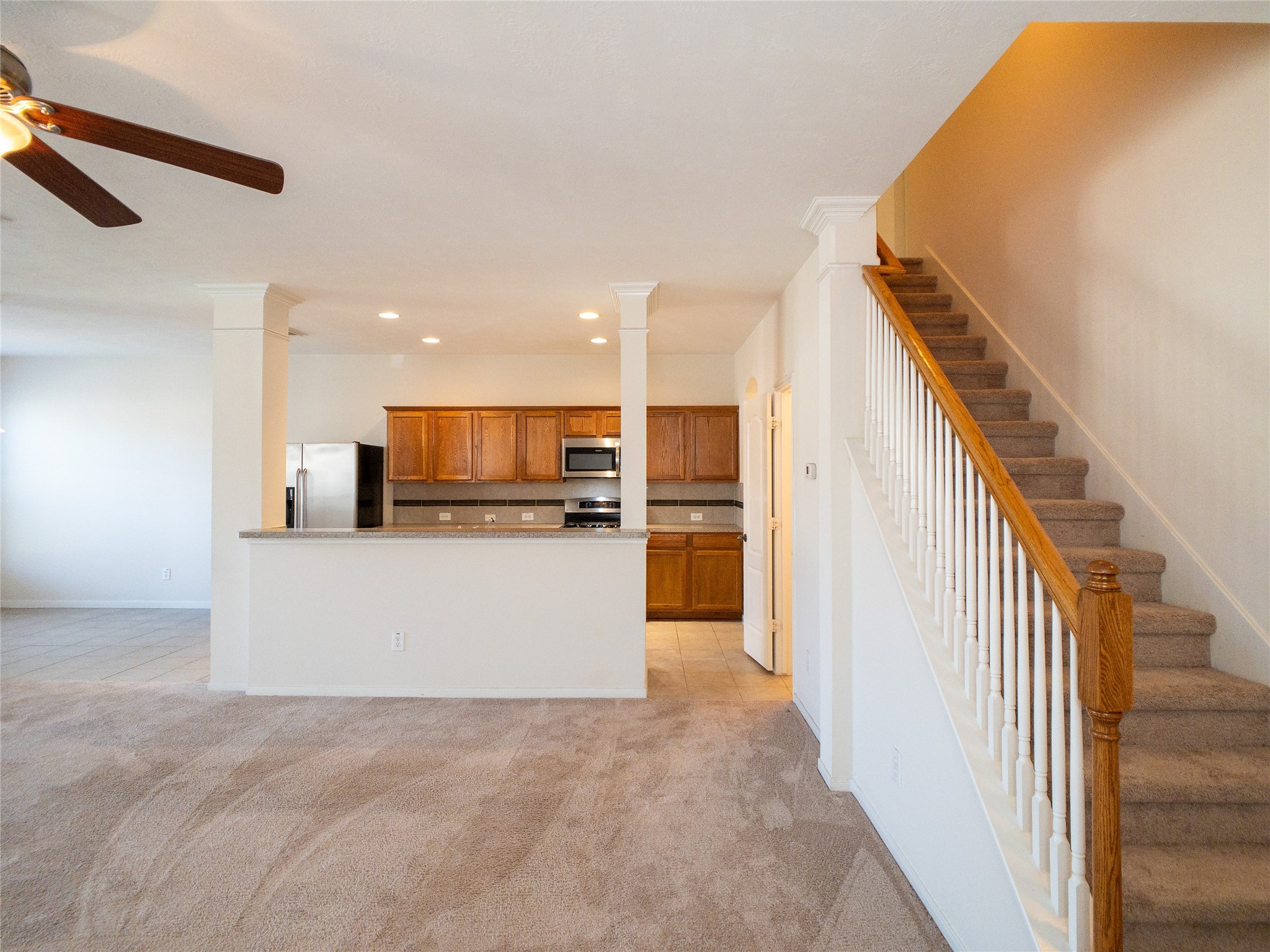 carpet & tile flooring, elegant columns with crown molding